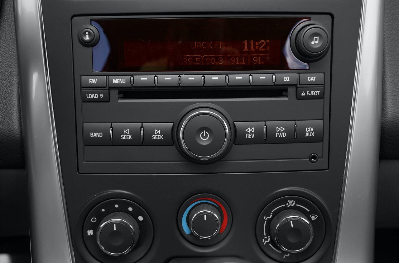 Car radio with FM presets and manual climate control knobs