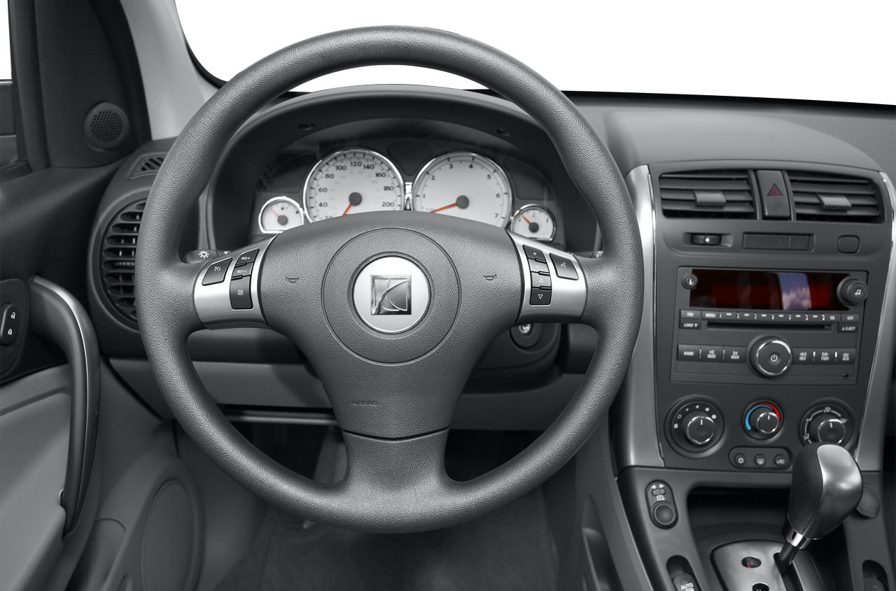 Steering wheel with controls and dashboard featuring audio and climate control