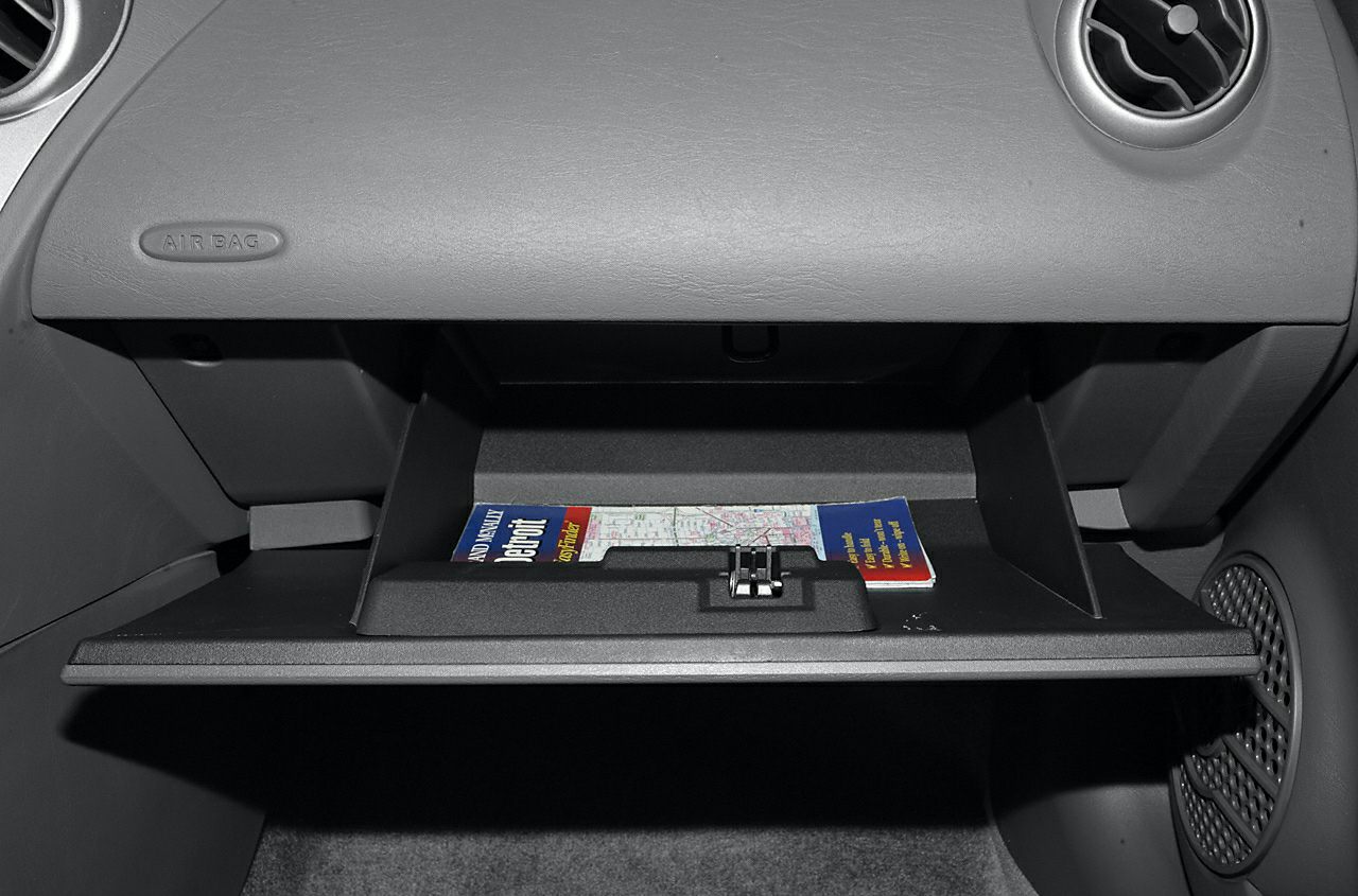 Glove compartment with a map inside a car dashboard