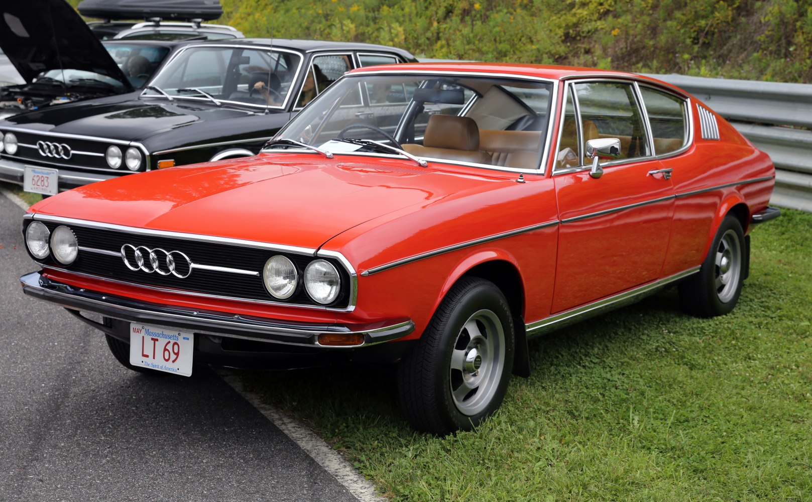 Vintage red coupe with quad round headlights and chrome trim