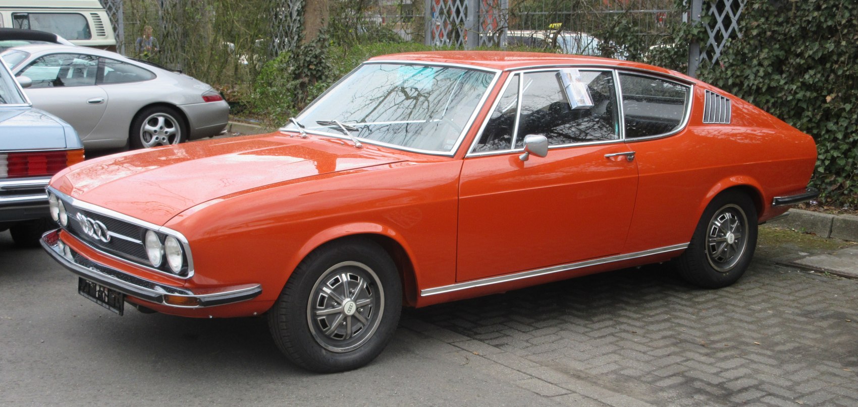 Orange vintage coupe with fastback design and quad headlights