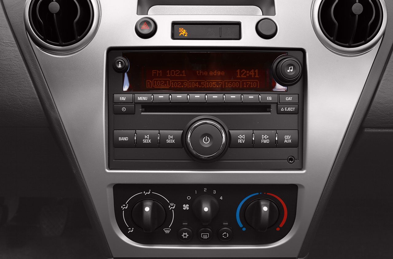 Car dashboard stereo system and climate control panel with knobs and buttons