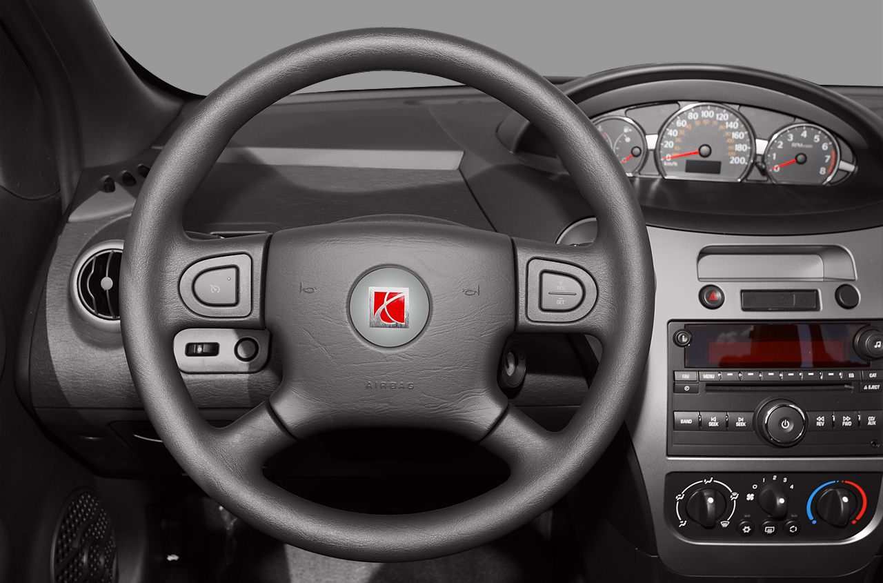 Dashboard and steering wheel with instrument cluster and control buttons