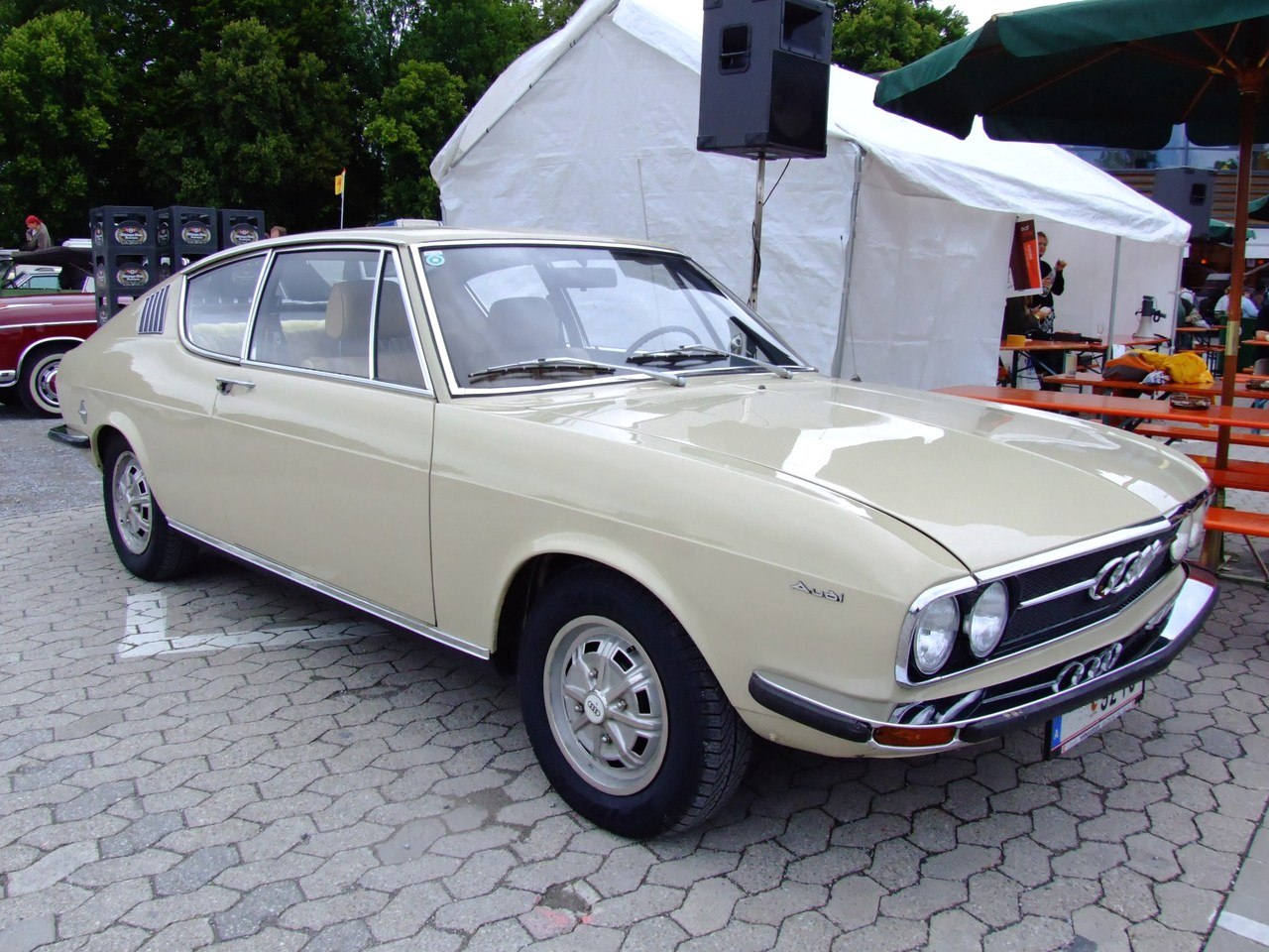 Vintage two-door coupe with dual round headlights and sleek body lines