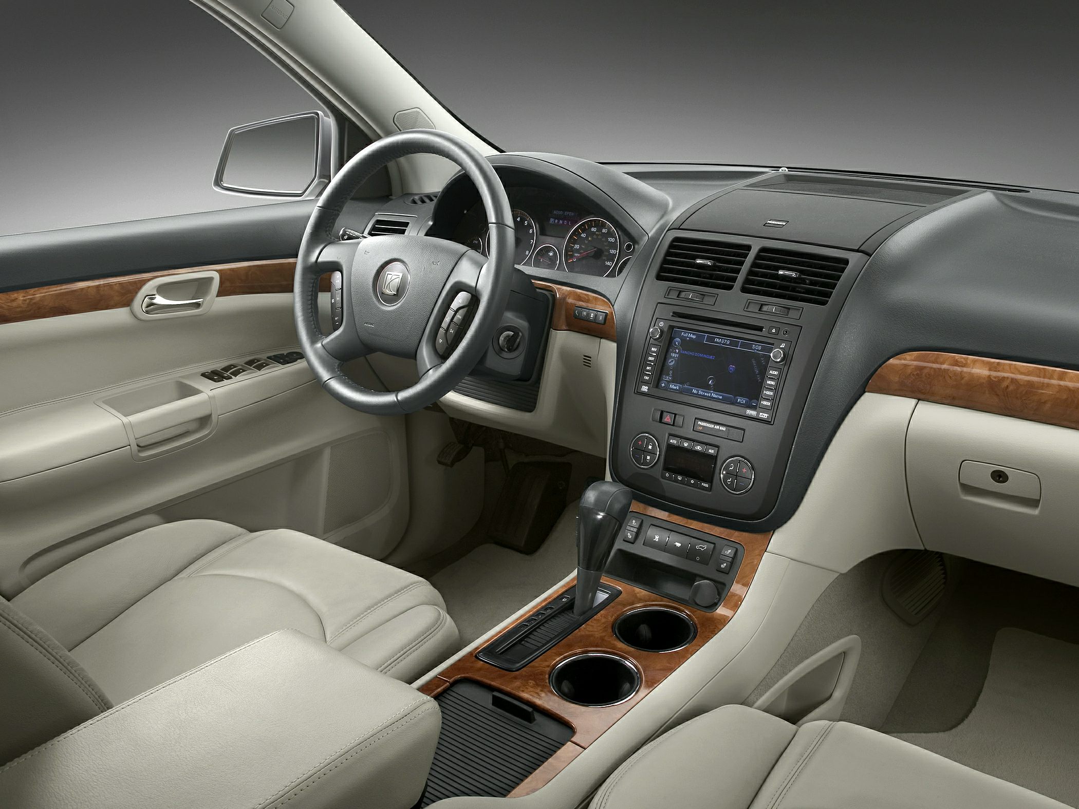 Luxury SUV interior with wood trim, navigation, and multifunction steering wheel