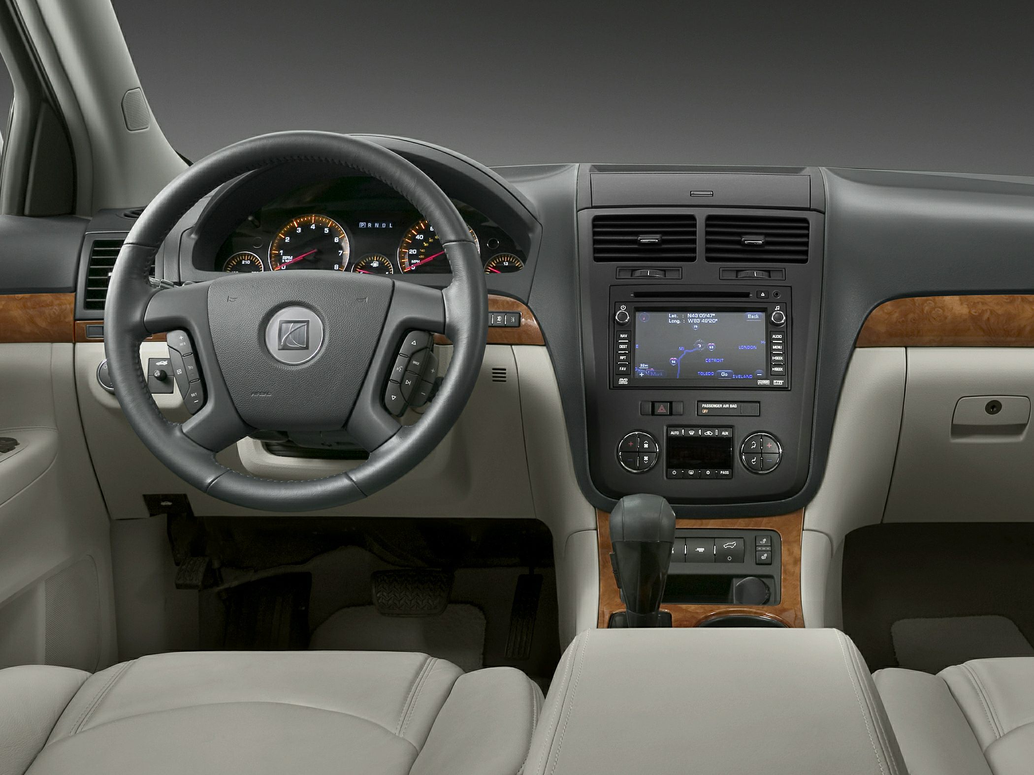 Leather steering wheel and central touchscreen navigation system in SUV interior