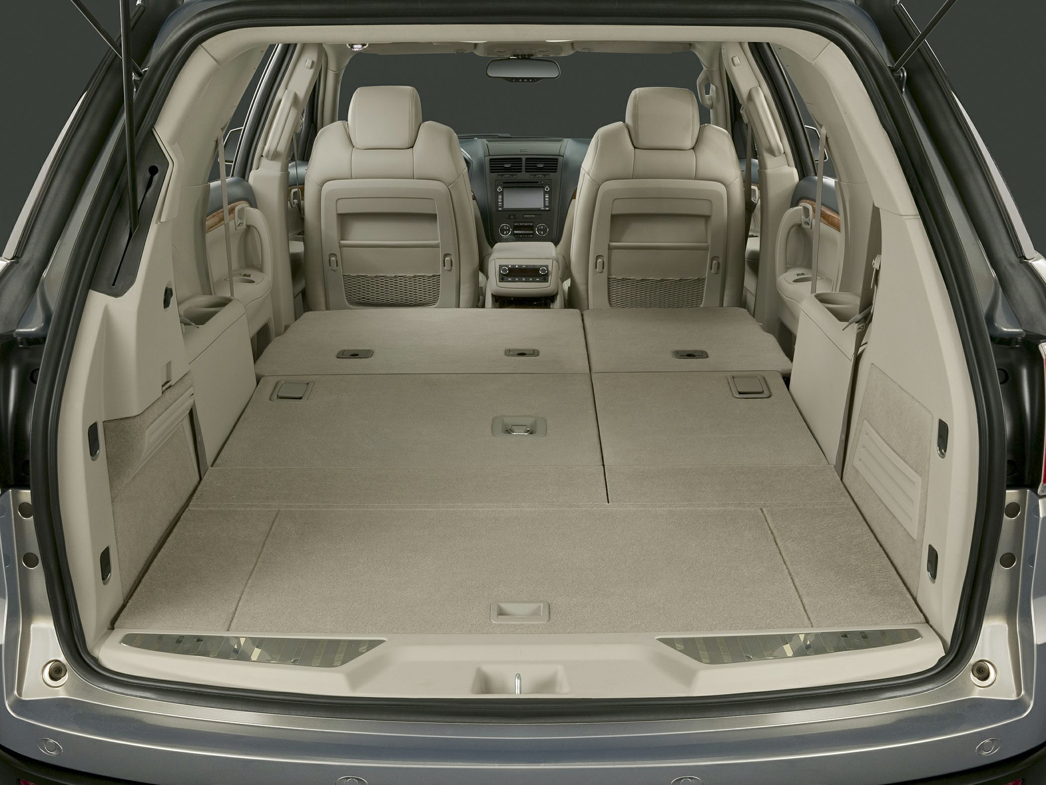 Folded rear seats creating flat and spacious cargo space in an SUV interior