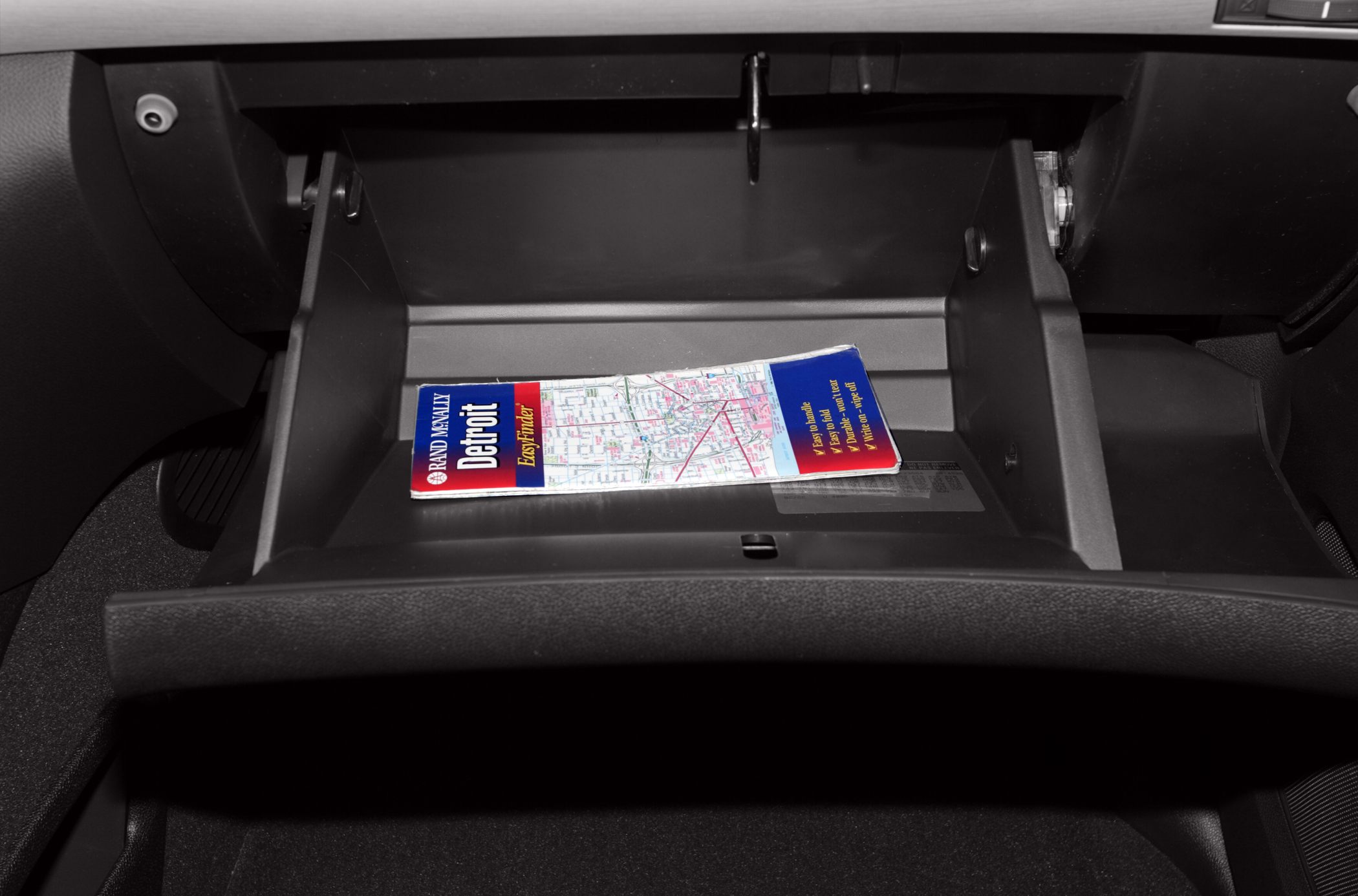 Open glove compartment with a folded map inside