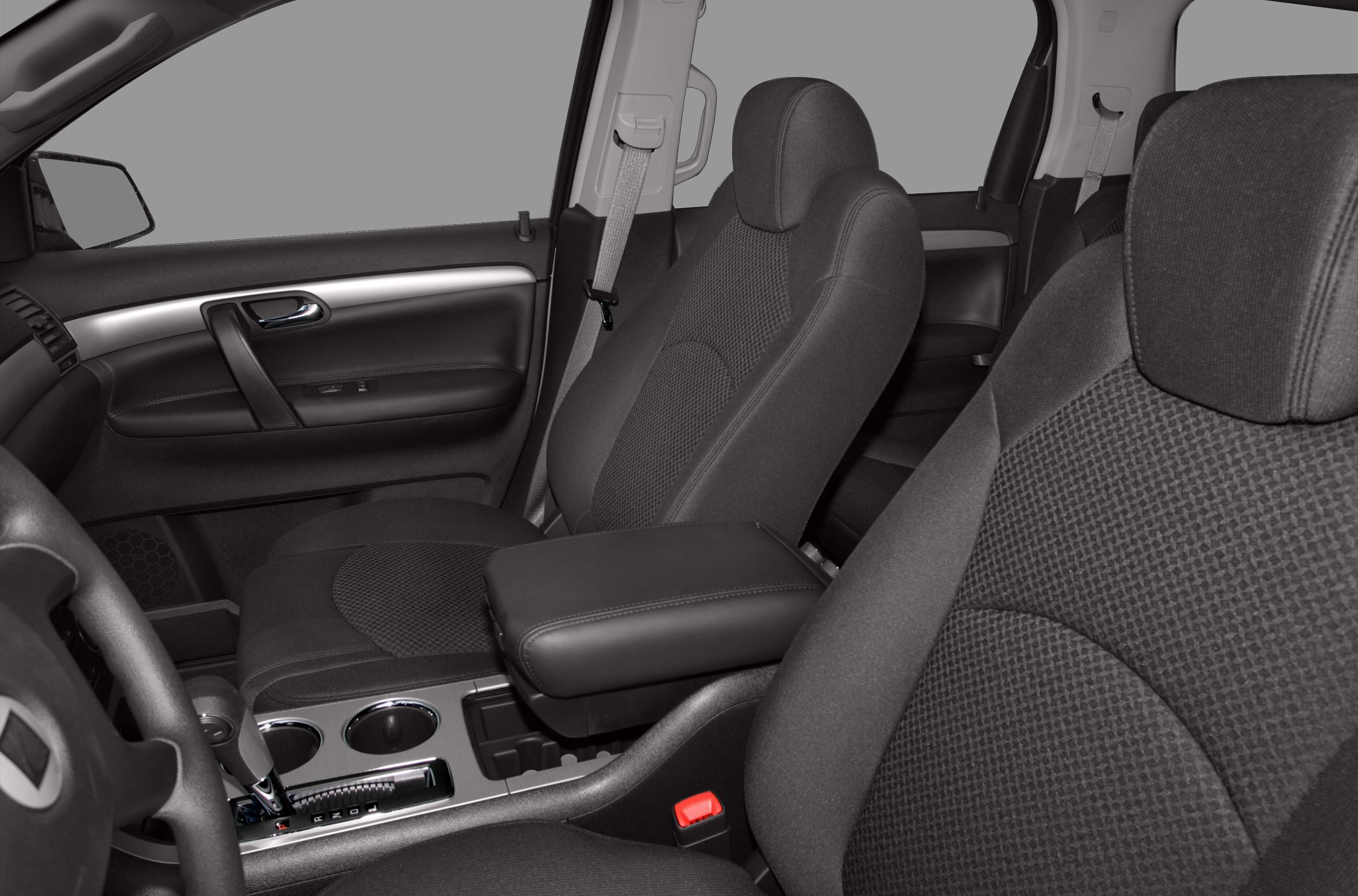 Front seats with fabric upholstery and center console including gear shift and cup holders