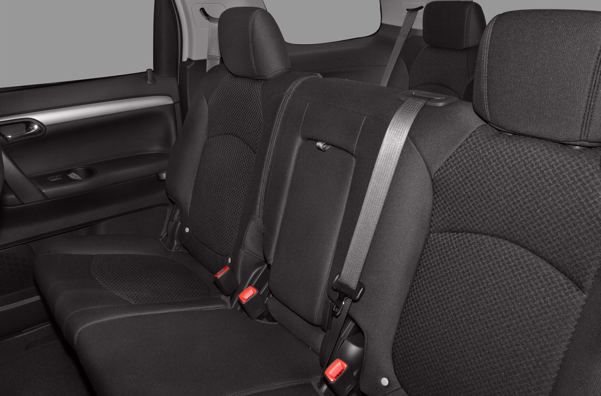 Rear seat interior with black fabric upholstery and seat belts