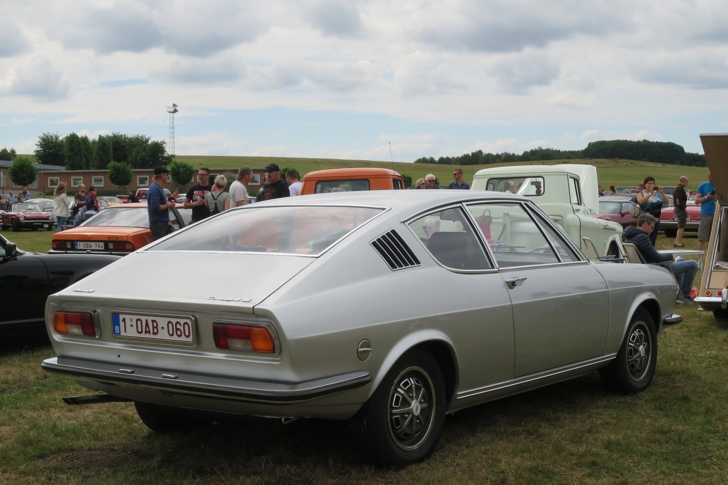 Silver vintage fastback coupe with rear side vents and angular body lines