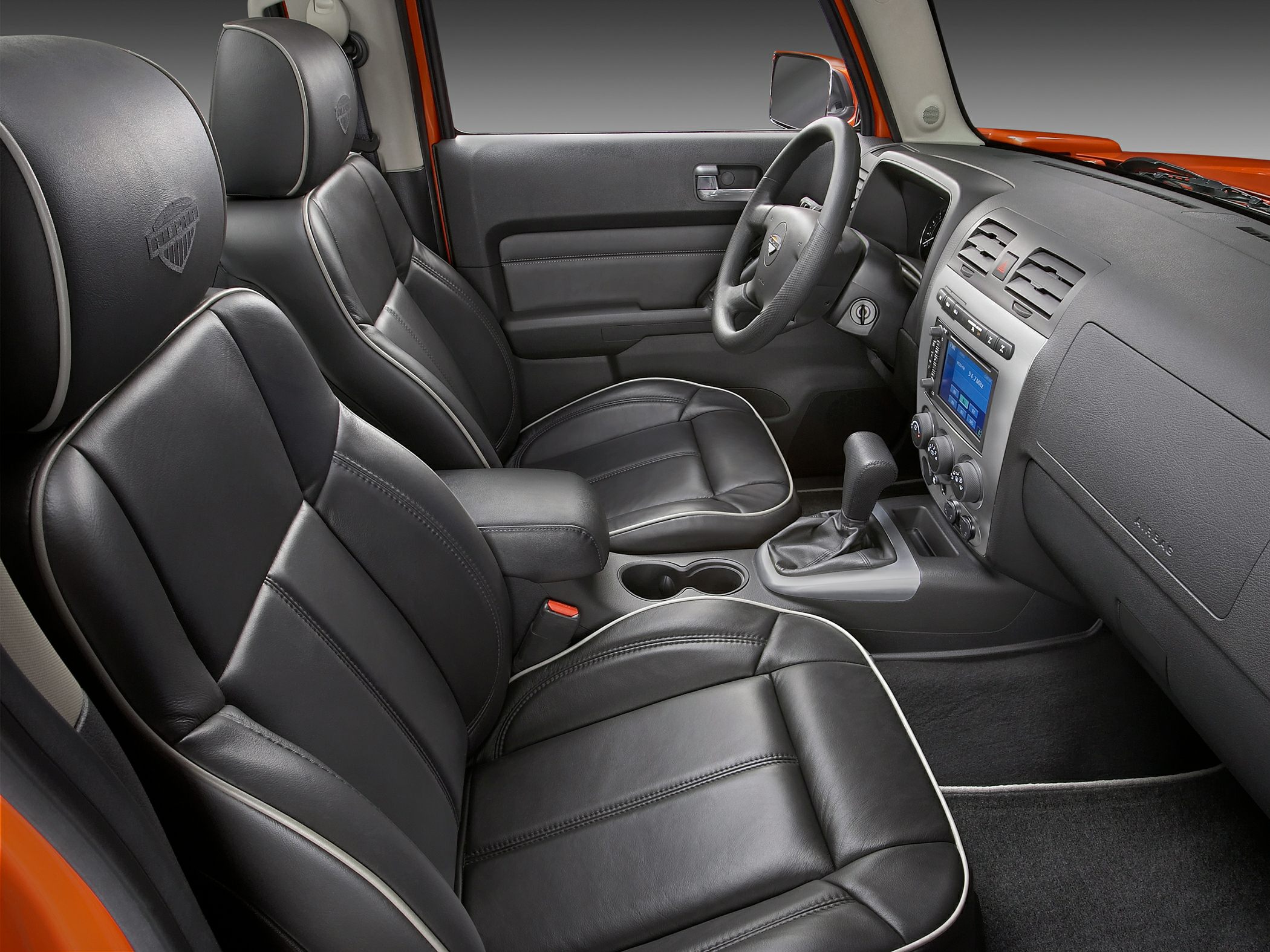Black leather seats with white piping and dashboard interior design