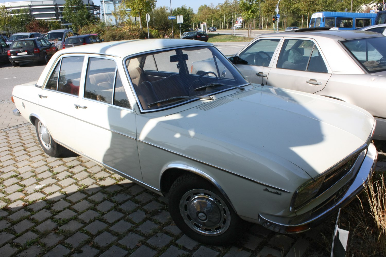Vintage sedan with chrome trim and distinctive wheel caps