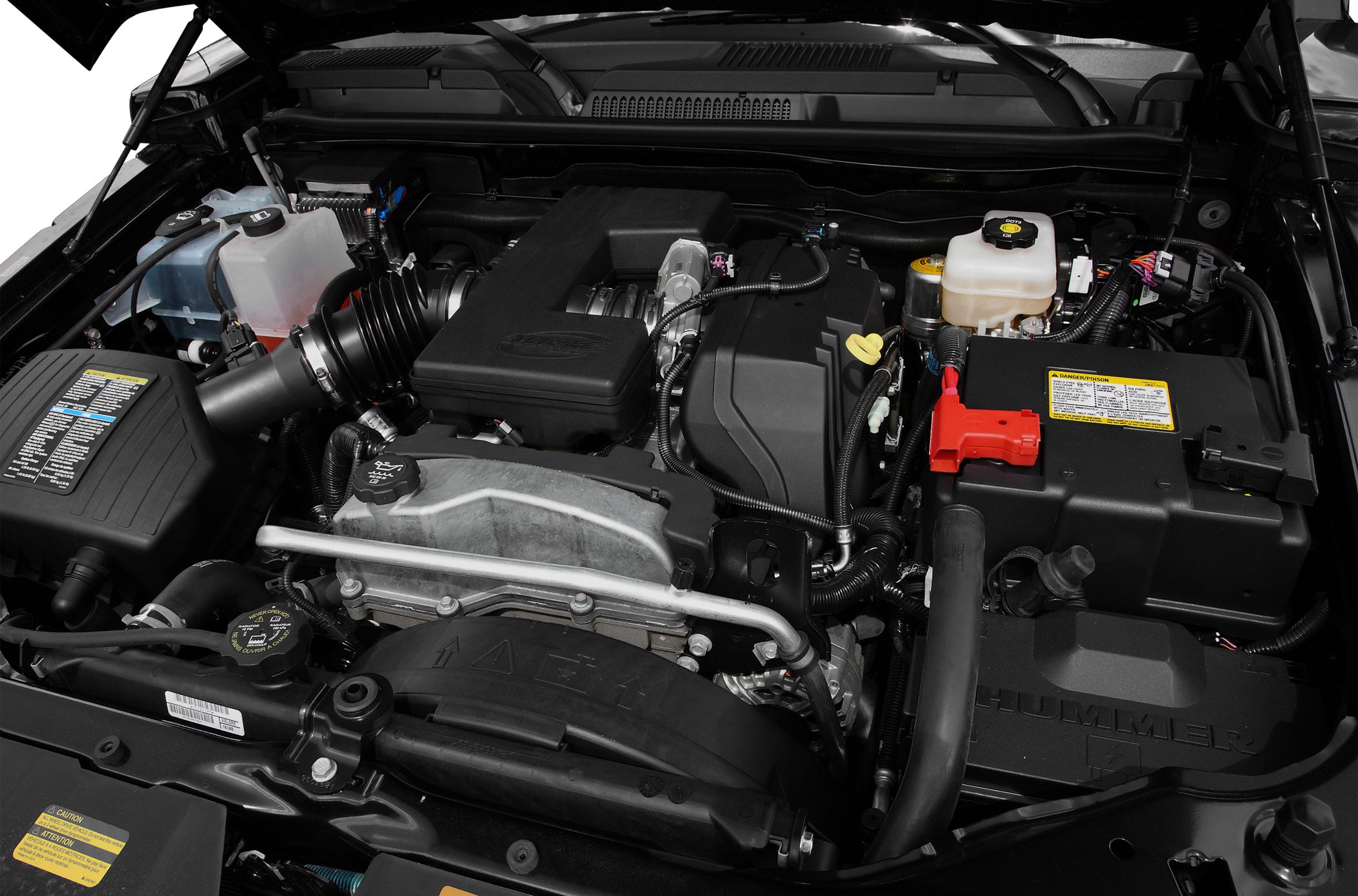 Close-up of engine bay with air intake, battery, and fluid reservoirs