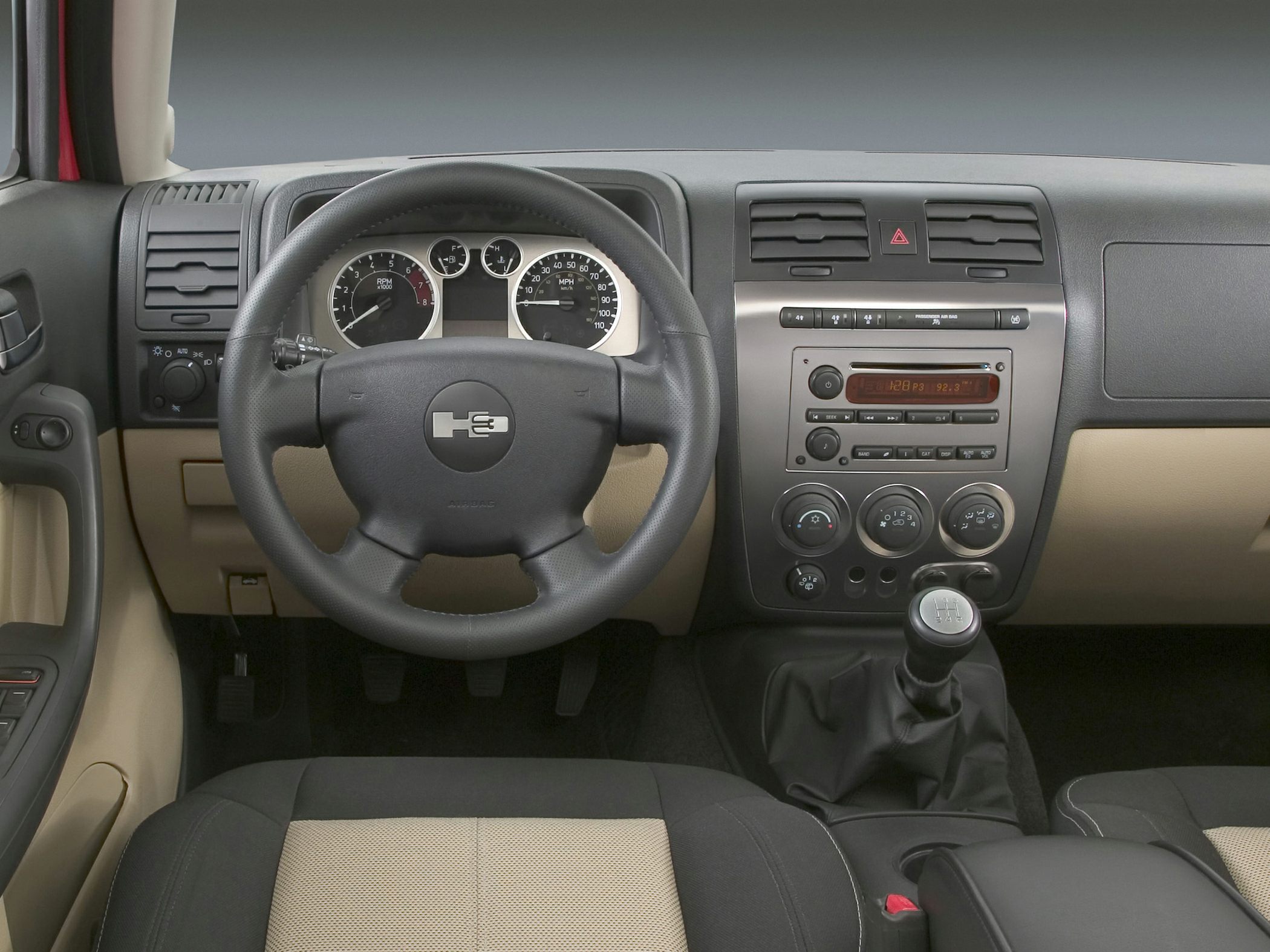 Dashboard with instrument cluster, steering wheel, and manual gear shift
