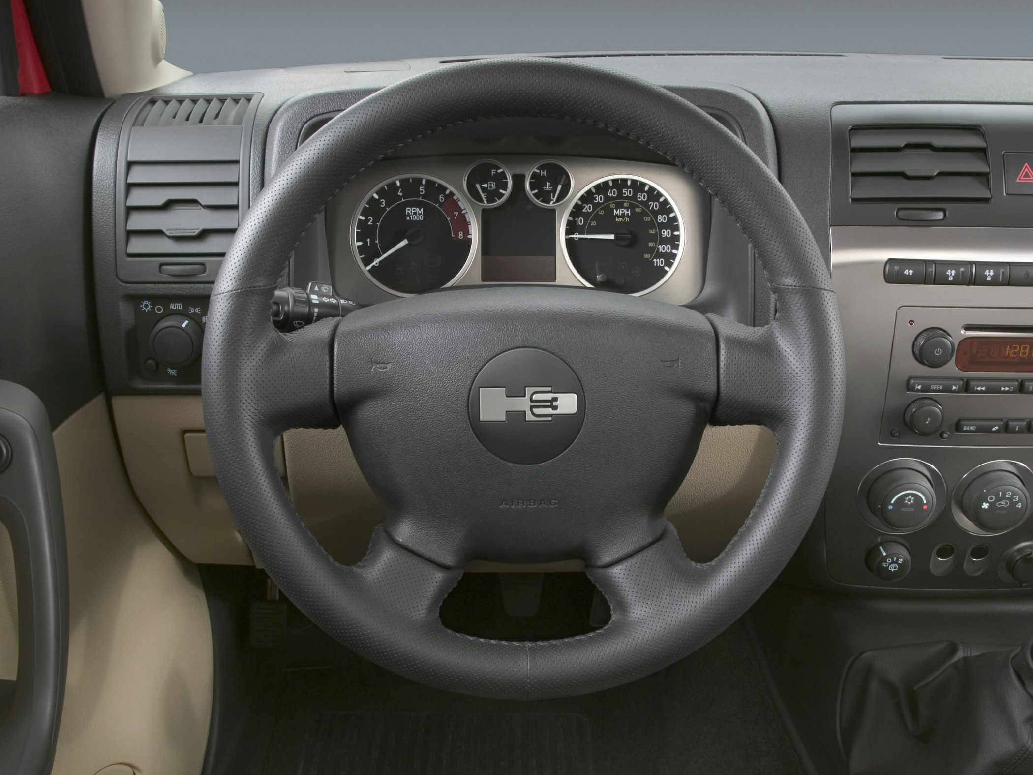 Close-up of a steering wheel with instrument cluster and control panel