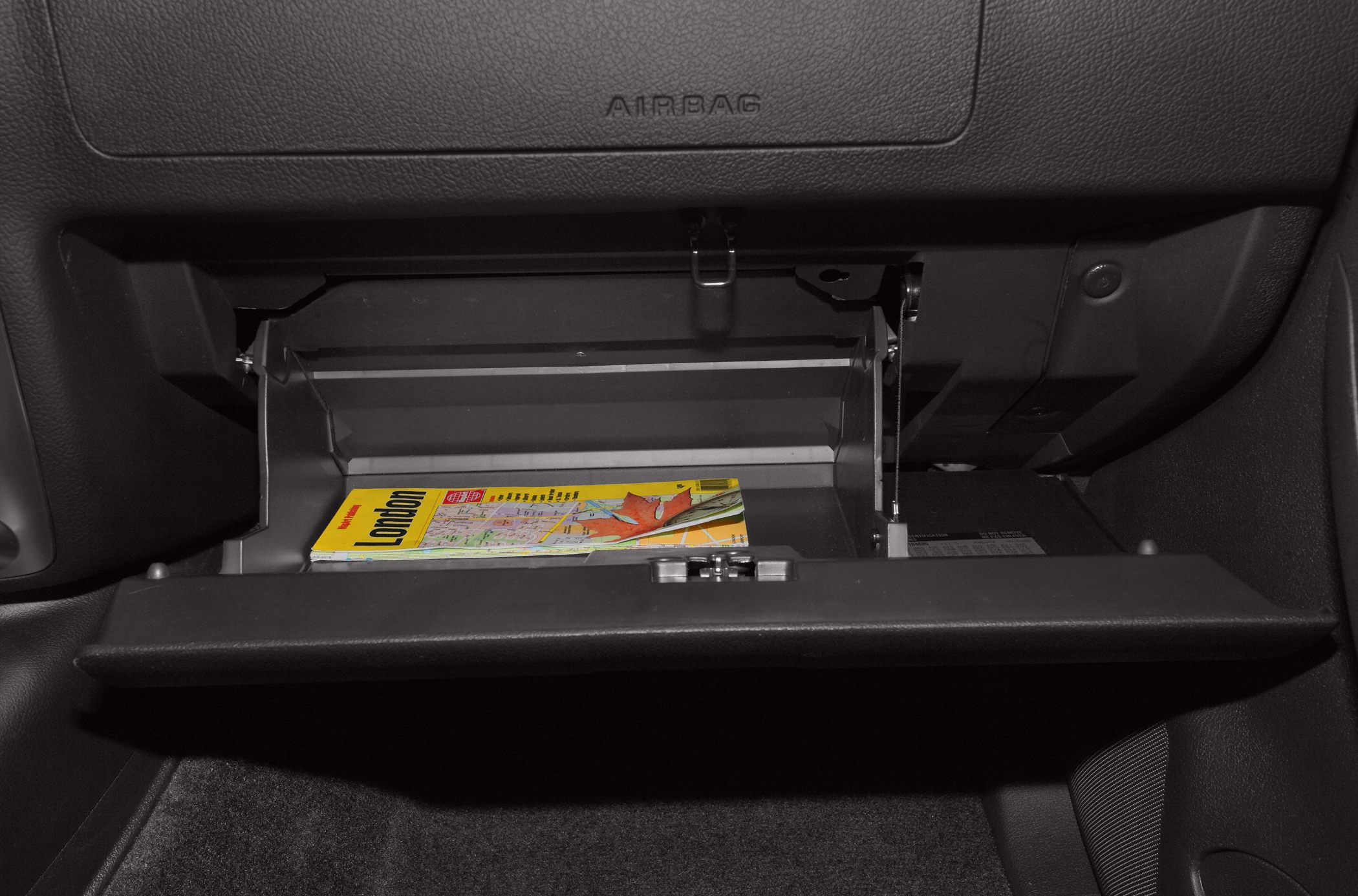 Open glove compartment with map inside