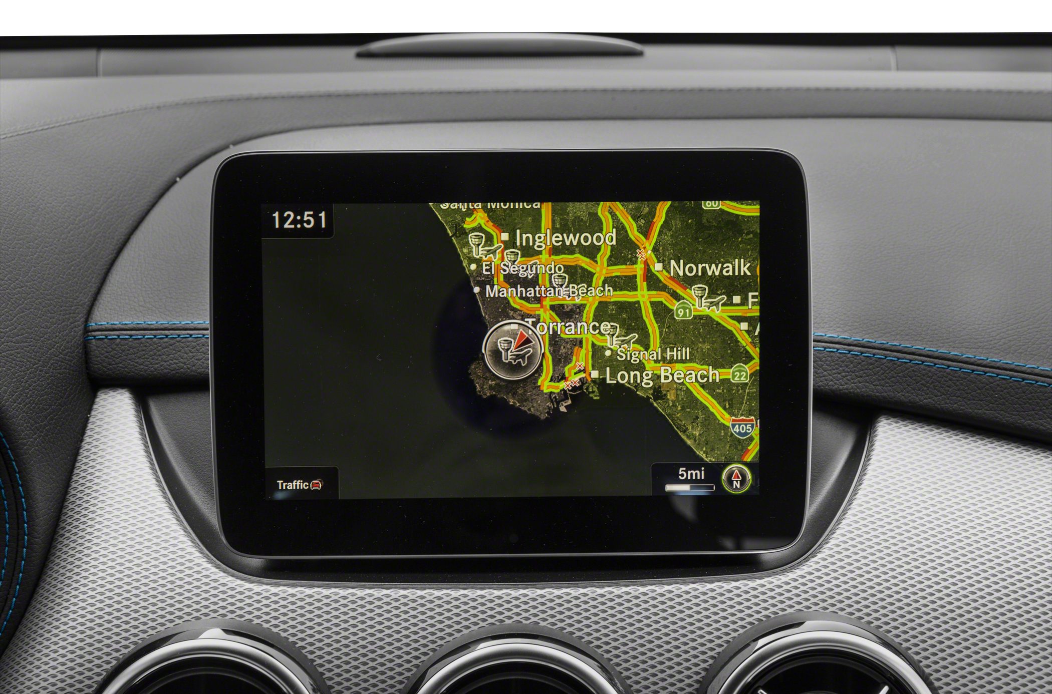 Car dashboard with navigation screen displaying traffic map.