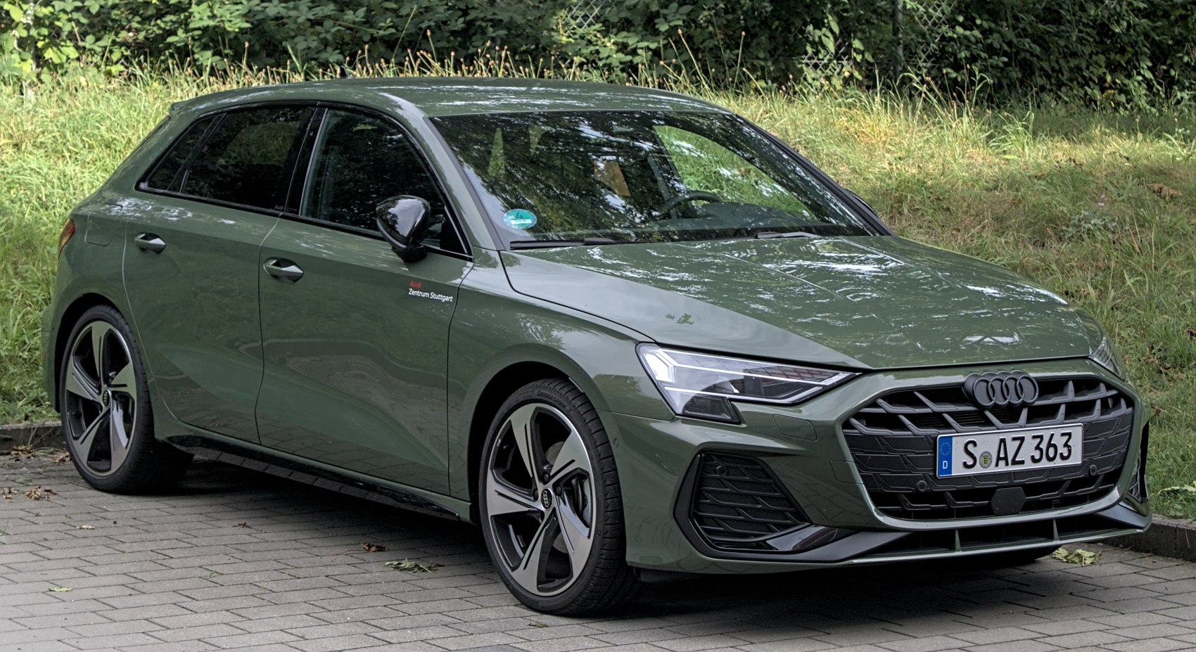 Sharp headlights and aggressive front grille with sleek five-spoke wheels