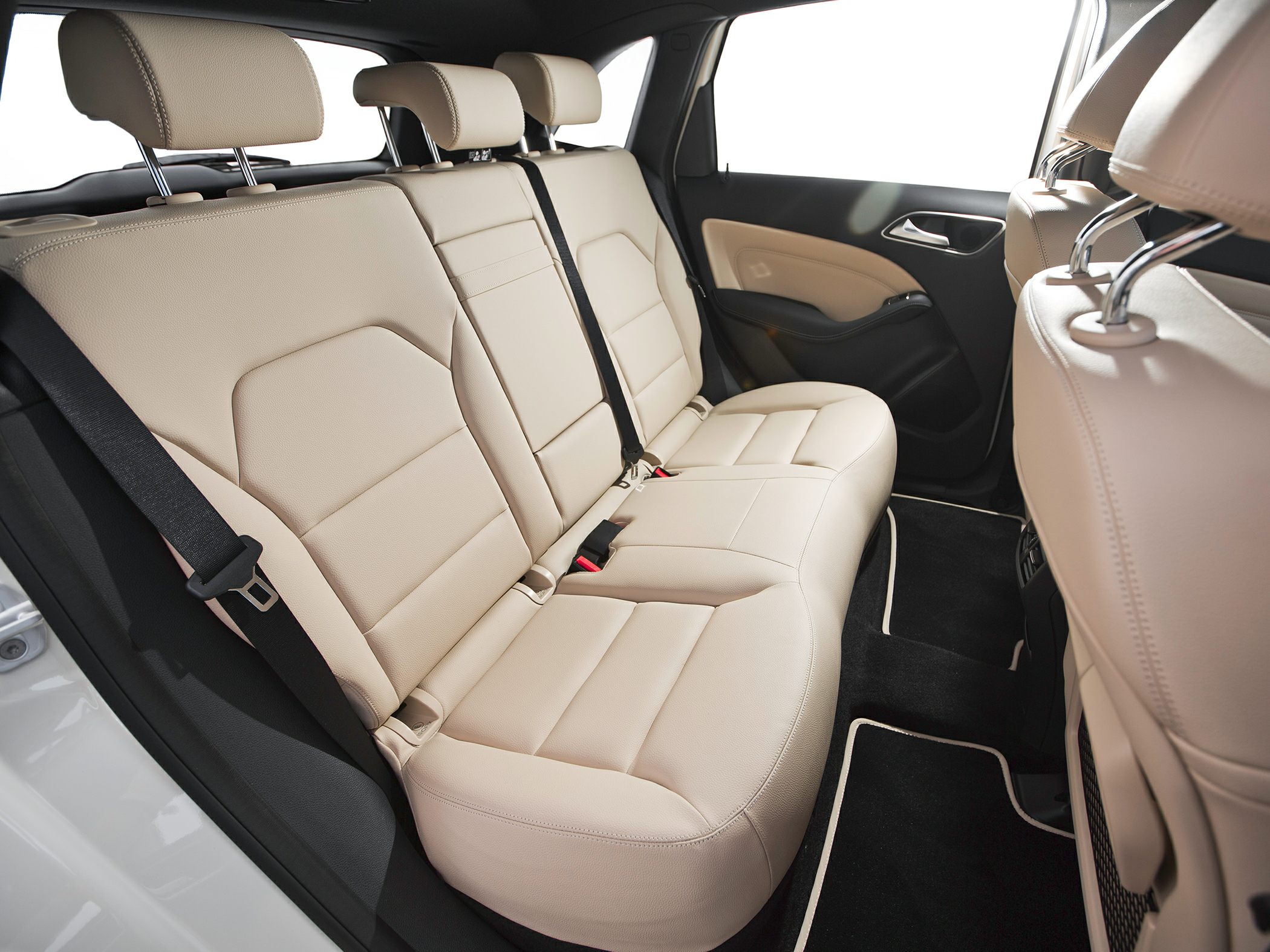 Beige leather rear seats with headrests and seat belts