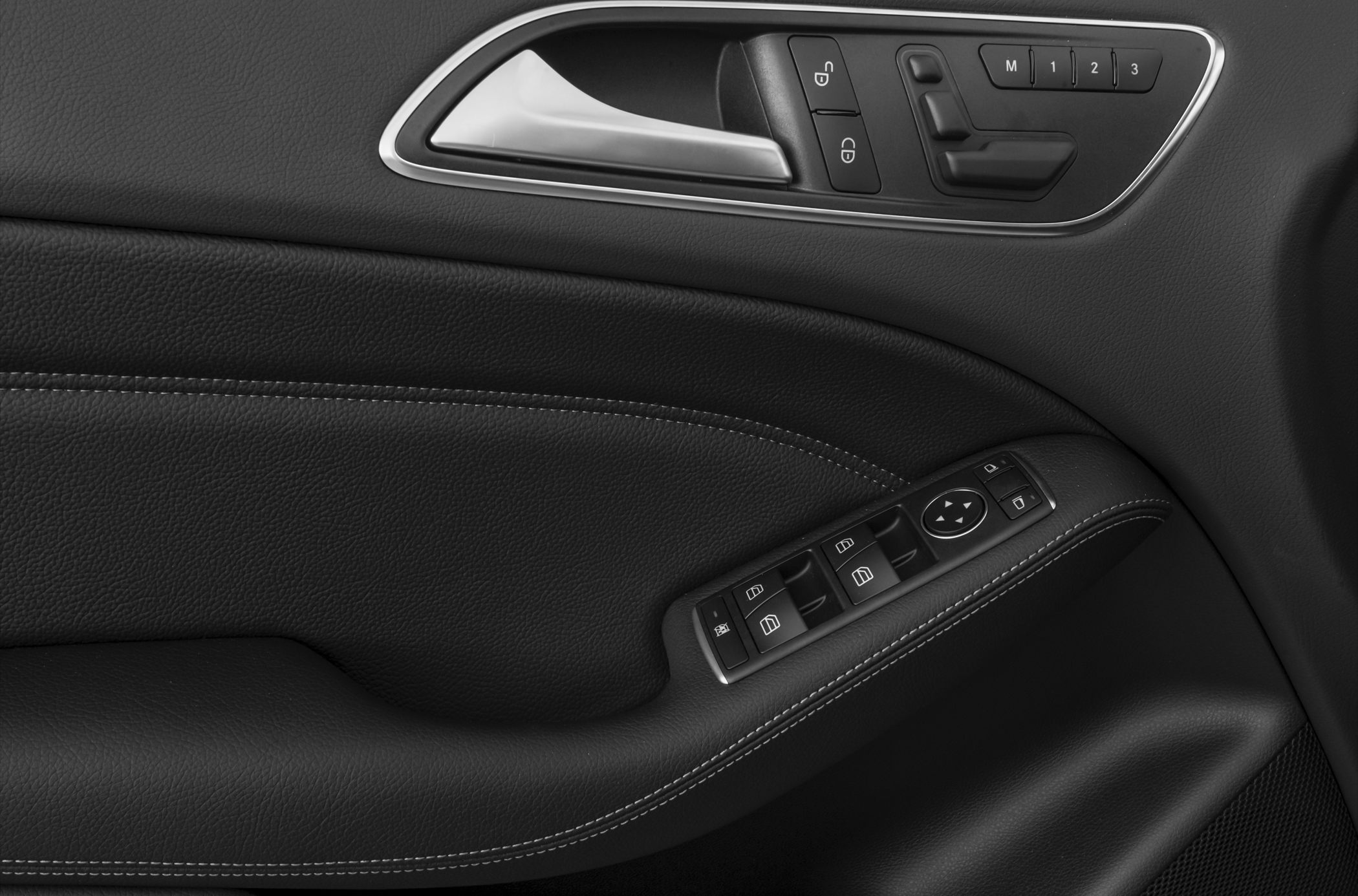 Door panel with window, lock controls, and memory seat buttons.