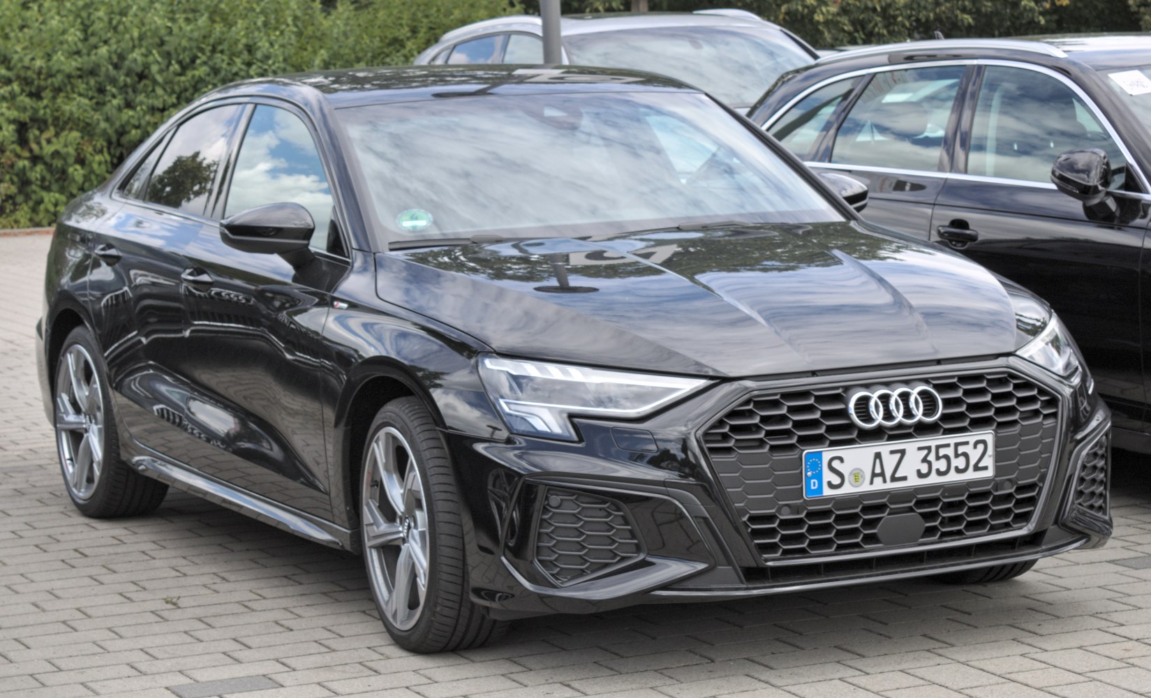 Front end with honeycomb hexagonal grille and angular LED headlights
