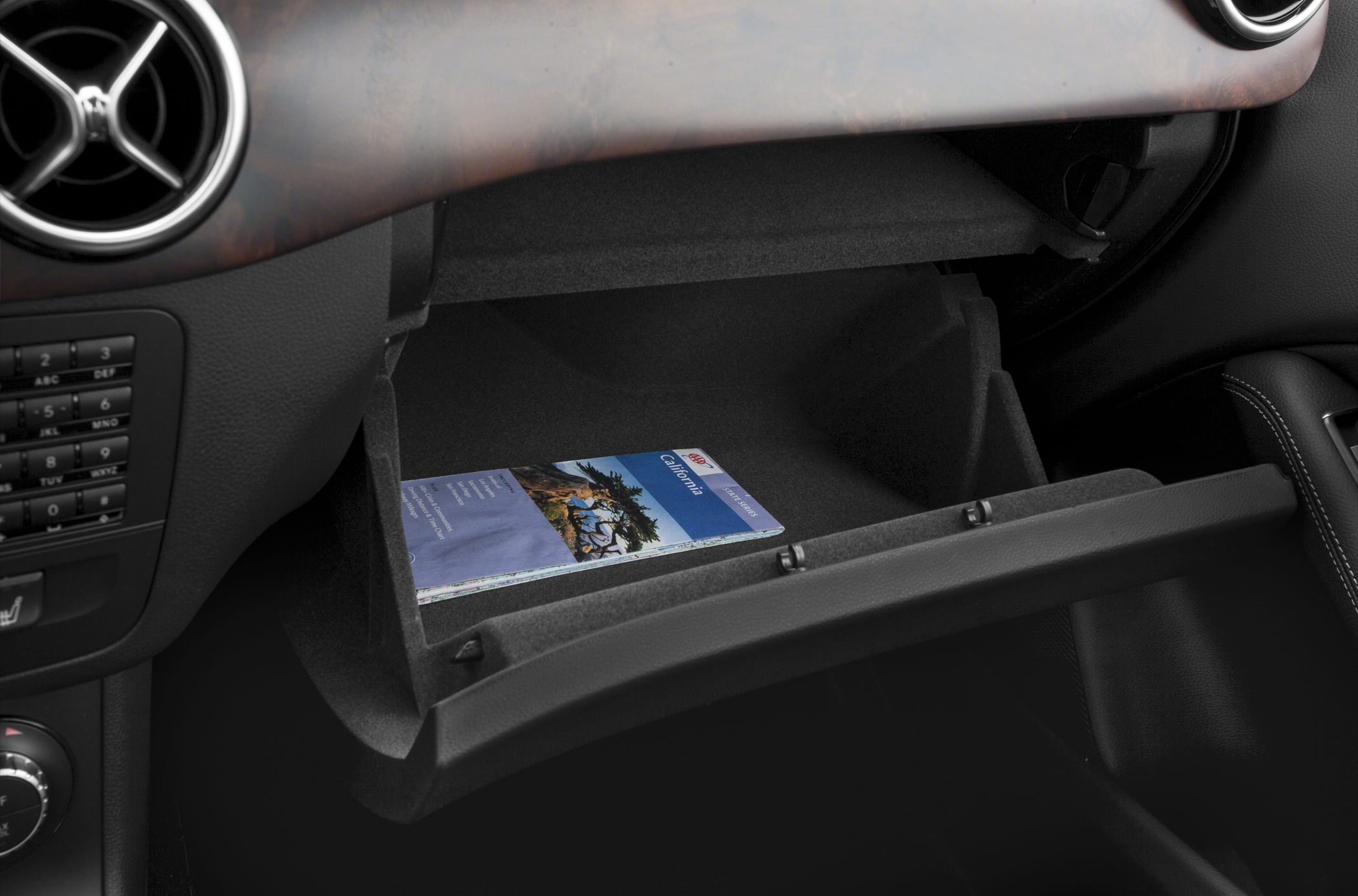 Open glove compartment with brochure inside