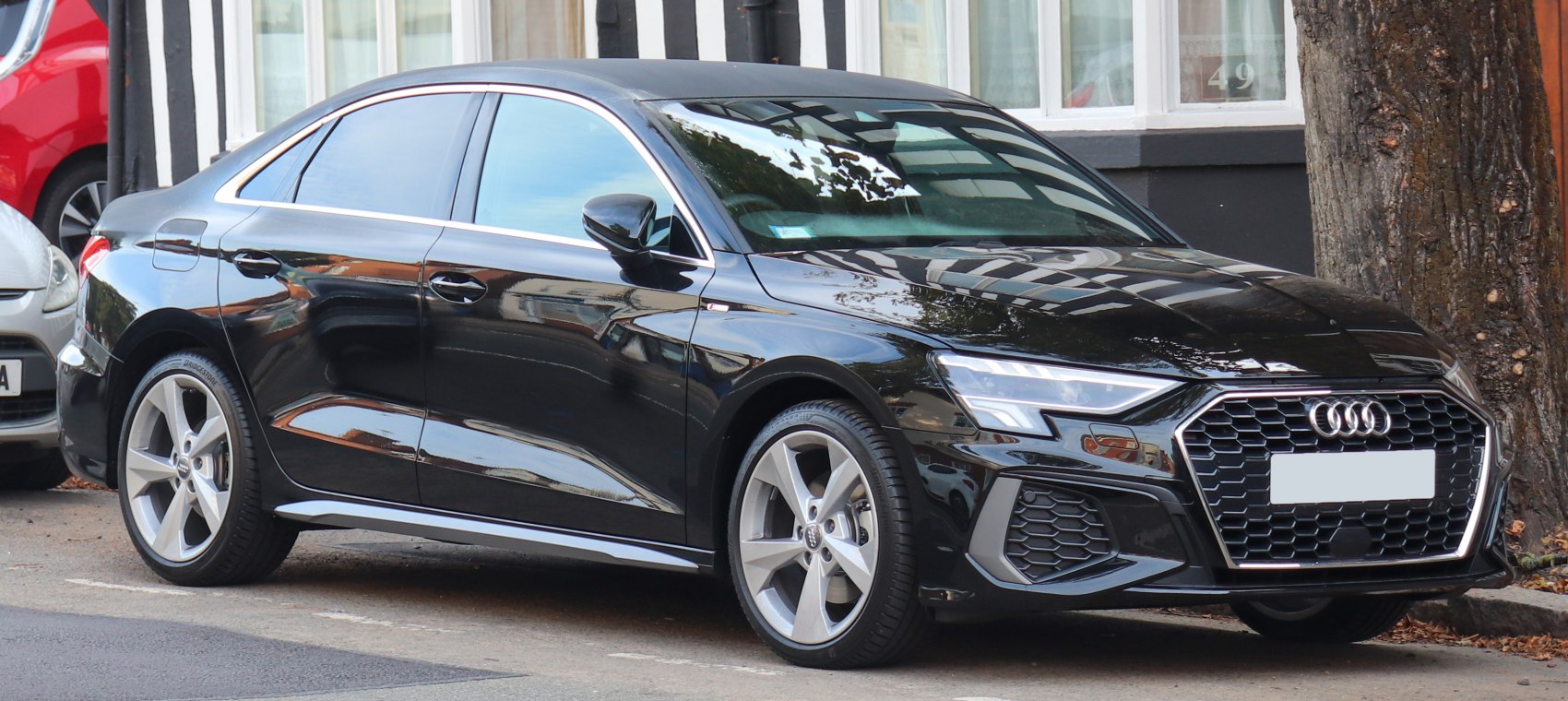 Modern black sedan with honeycomb grille and LED headlights