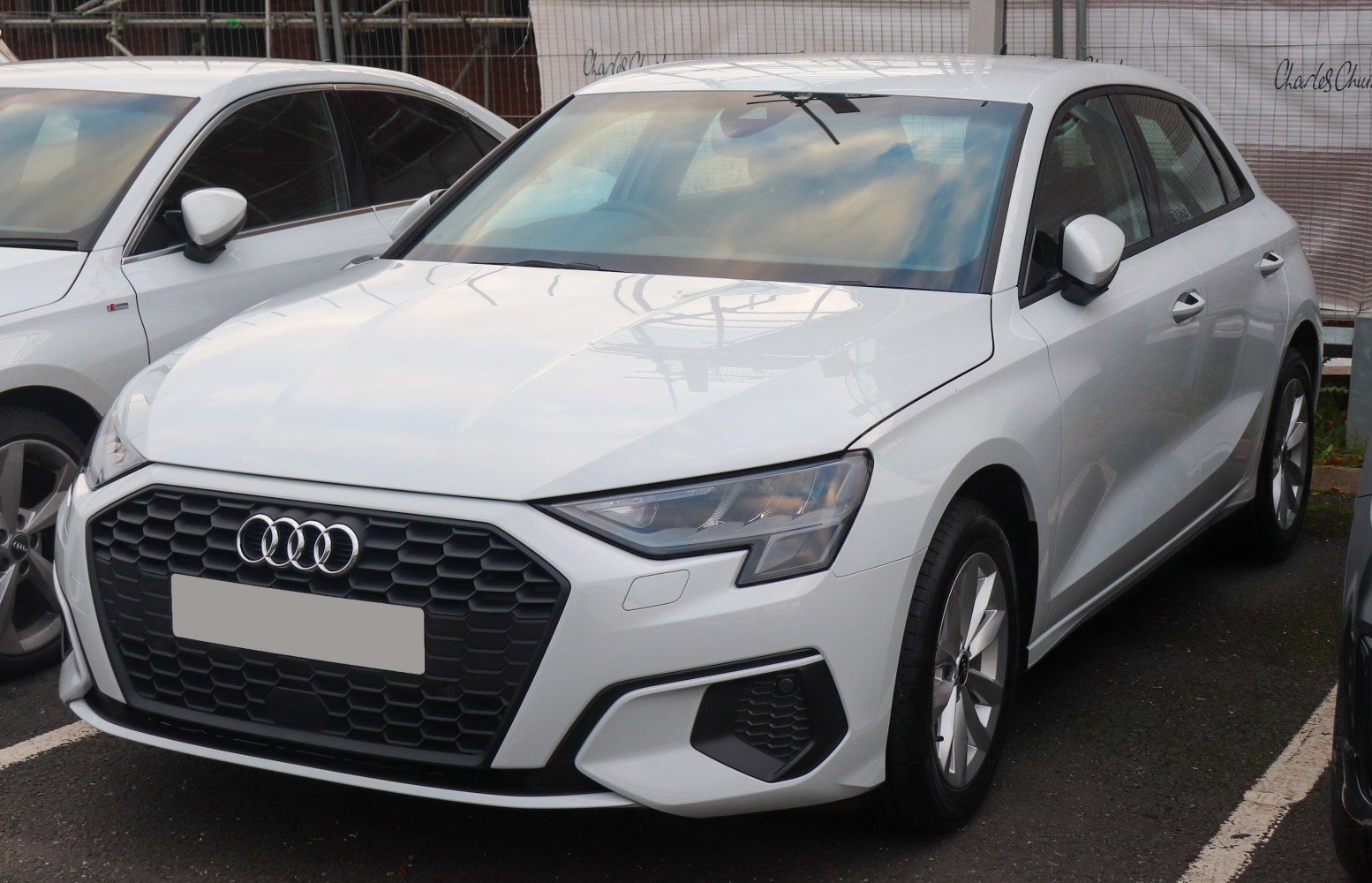 Front view of a hatchback with hexagonal grille and LED headlights