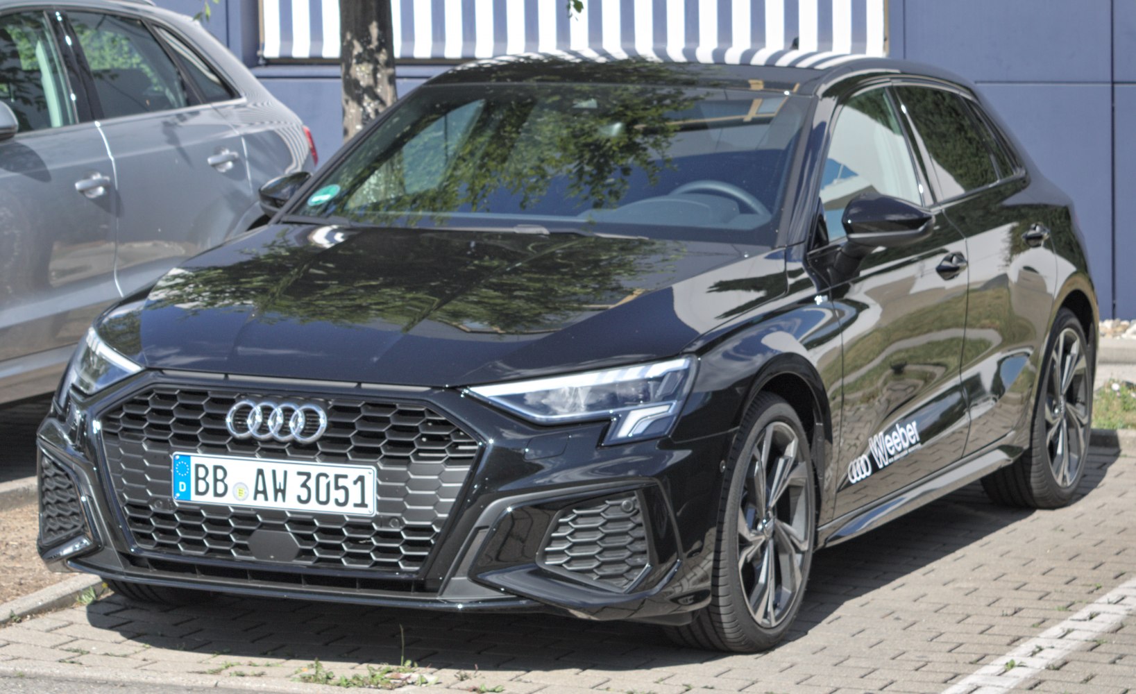 Front view with hexagonal grille, LED headlights, and alloy wheels