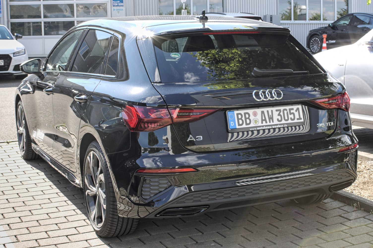 Rear view of a modern hatchback with distinct taillights and tinted rear window