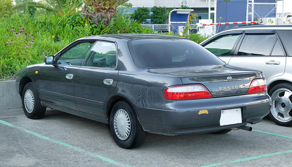 Sedan rear side view with classic taillights and rear bumper.