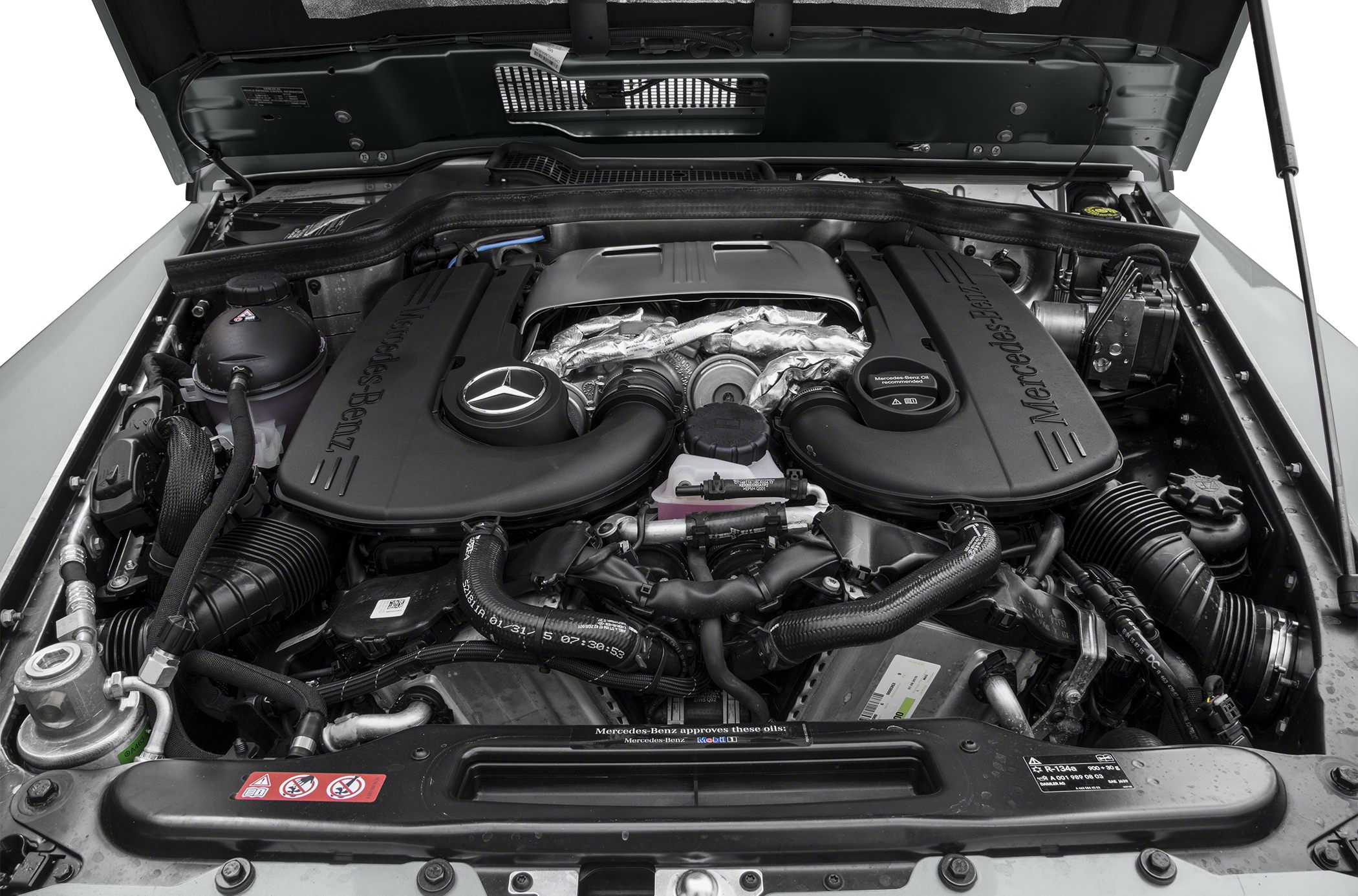 Mercedes-Benz engine bay with large engine cover and visible components