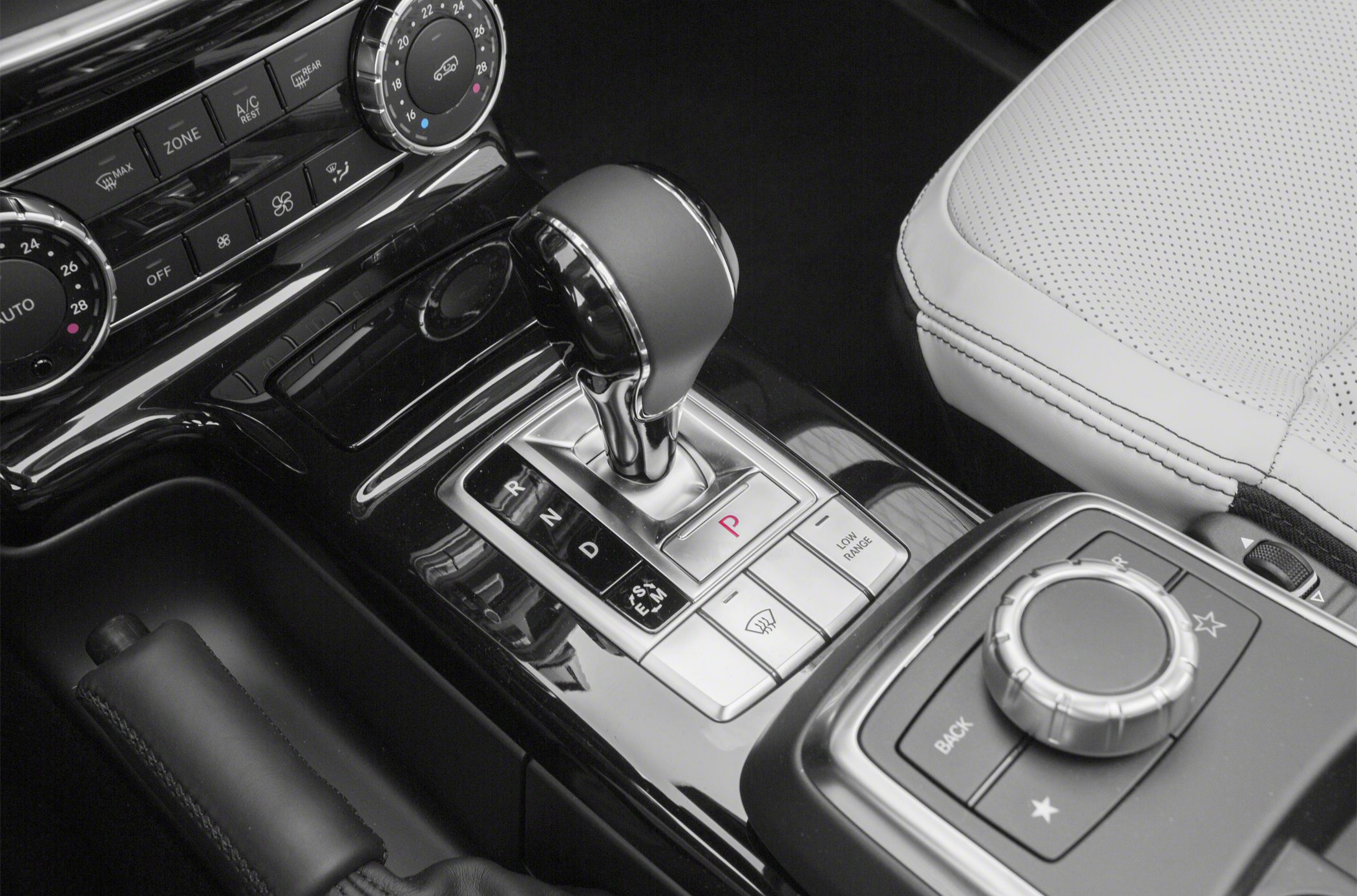 Automatic gear shift, climate control dials, and central console control knob