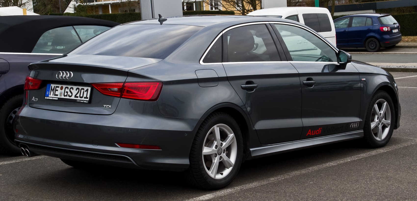 Rear side view of sedan with TDI badge and alloy wheels