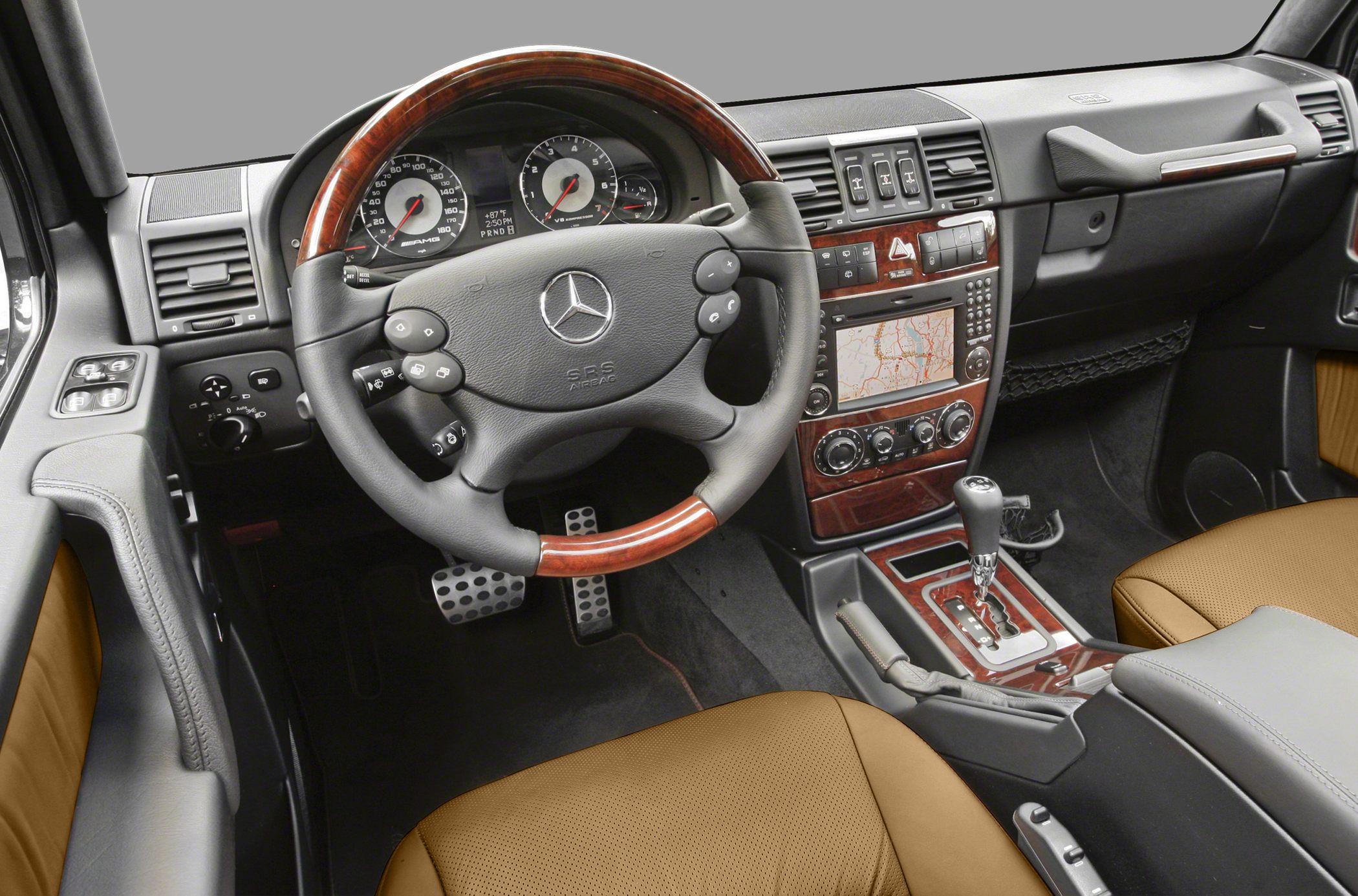 Luxury SUV interior with wood trim steering wheel and advanced dashboard controls