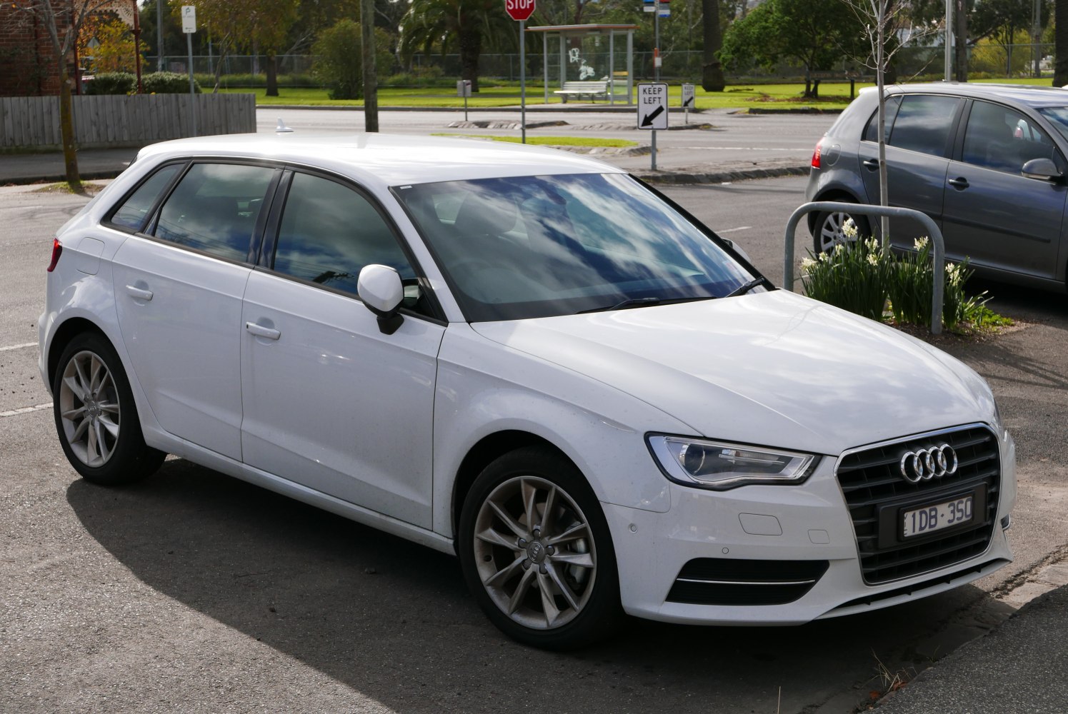 White five-door hatchback with sharp headlights and alloy wheels