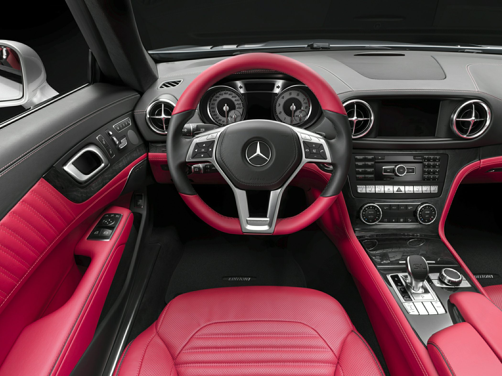 Red leather interior with steering wheel and dashboard