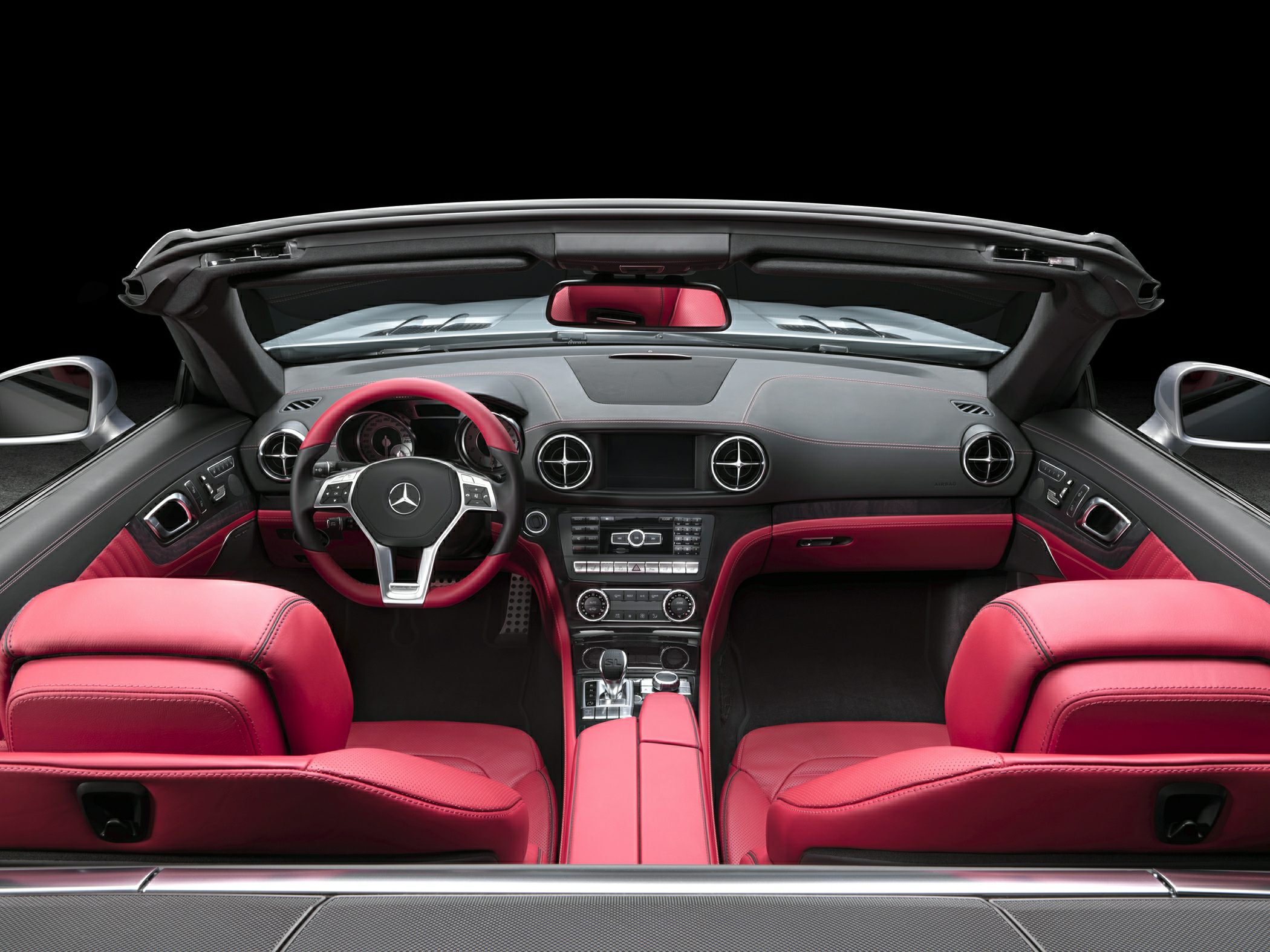 Luxurious red and black convertible interior with premium leather seats and modern dashboard
