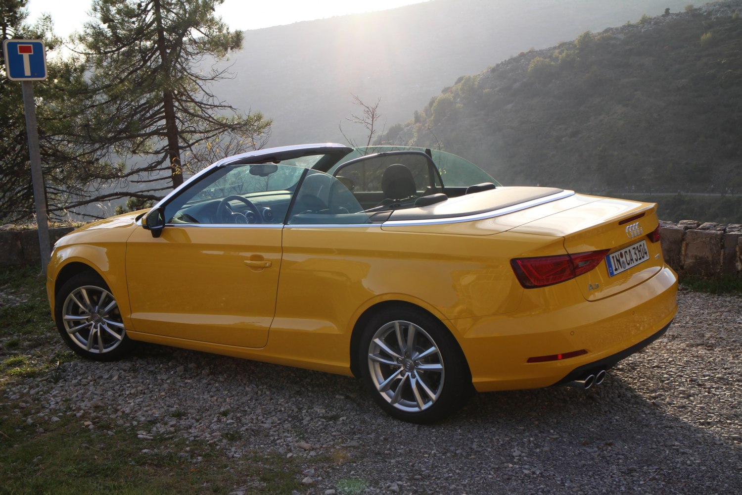 Yellow convertible with open roof and dual exhaust