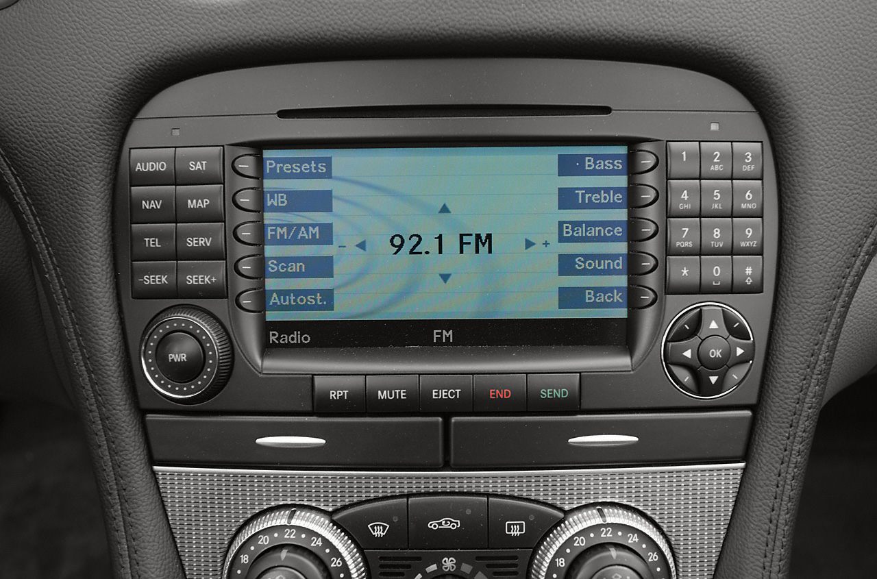 Digital radio interface and dual climate control knobs in car dashboard