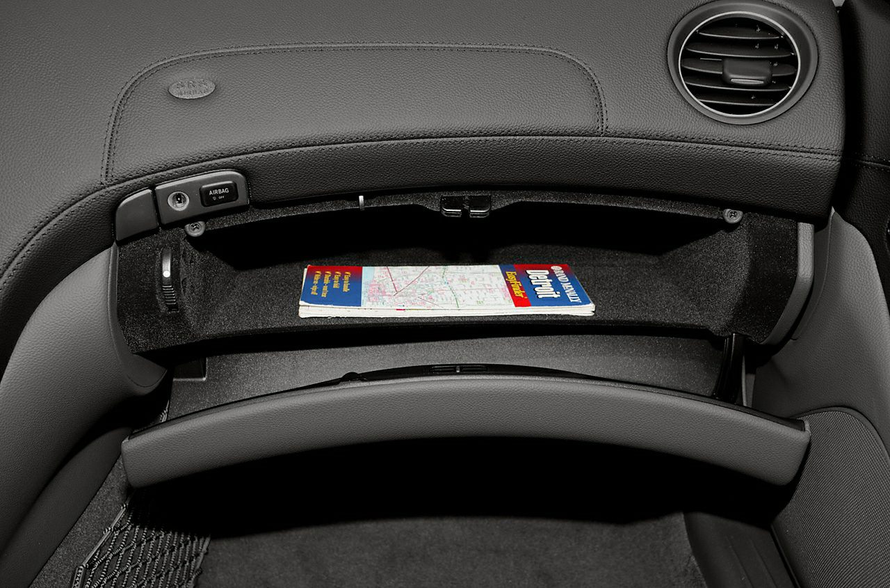Open glovebox with map in luxury car interior