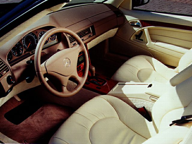 Beige leather seats and advanced dashboard with steering wheel in luxury car interior