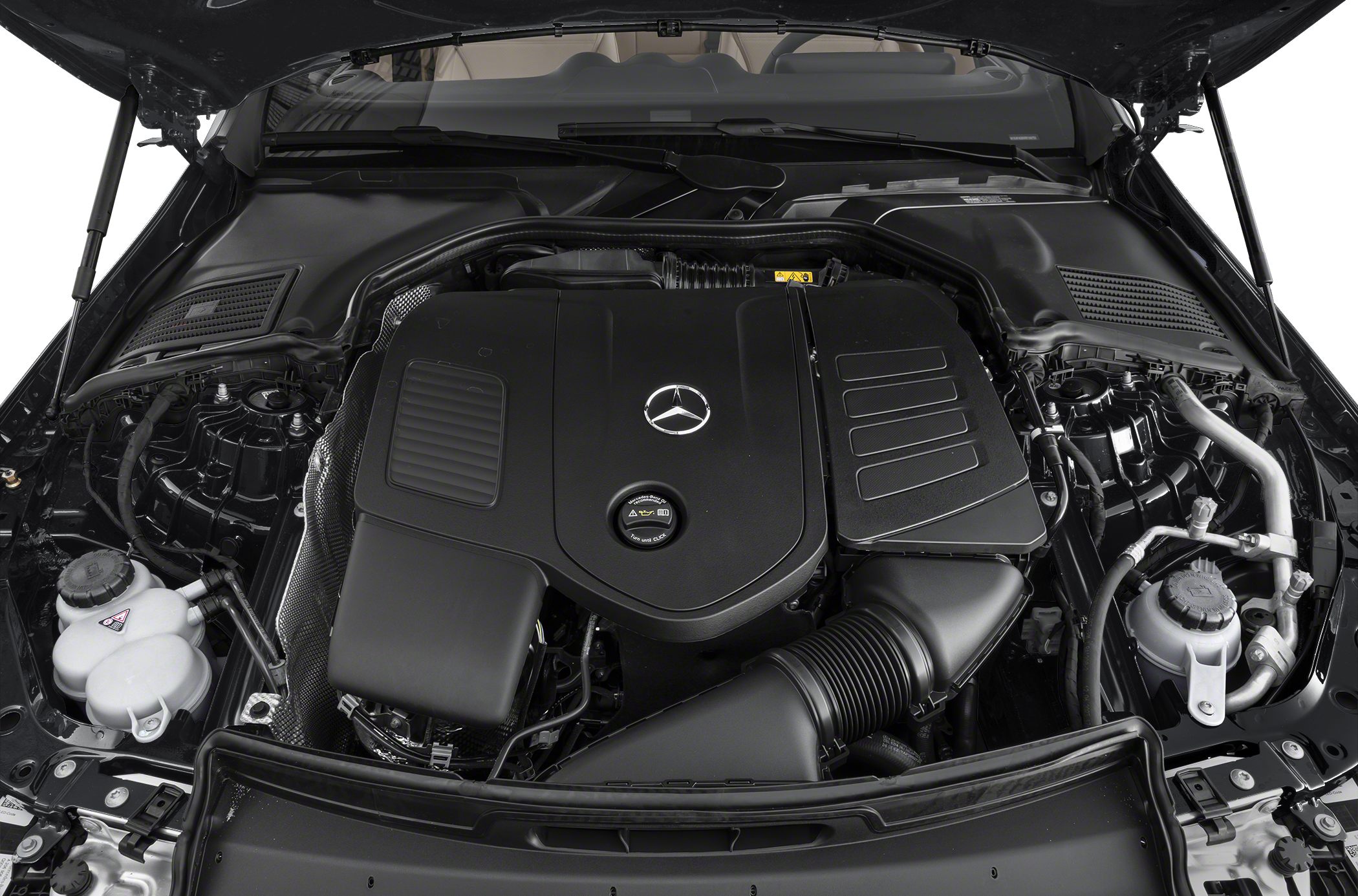 Engine bay with Mercedes-Benz logo on engine cover, showing intake and fluid reservoirs.