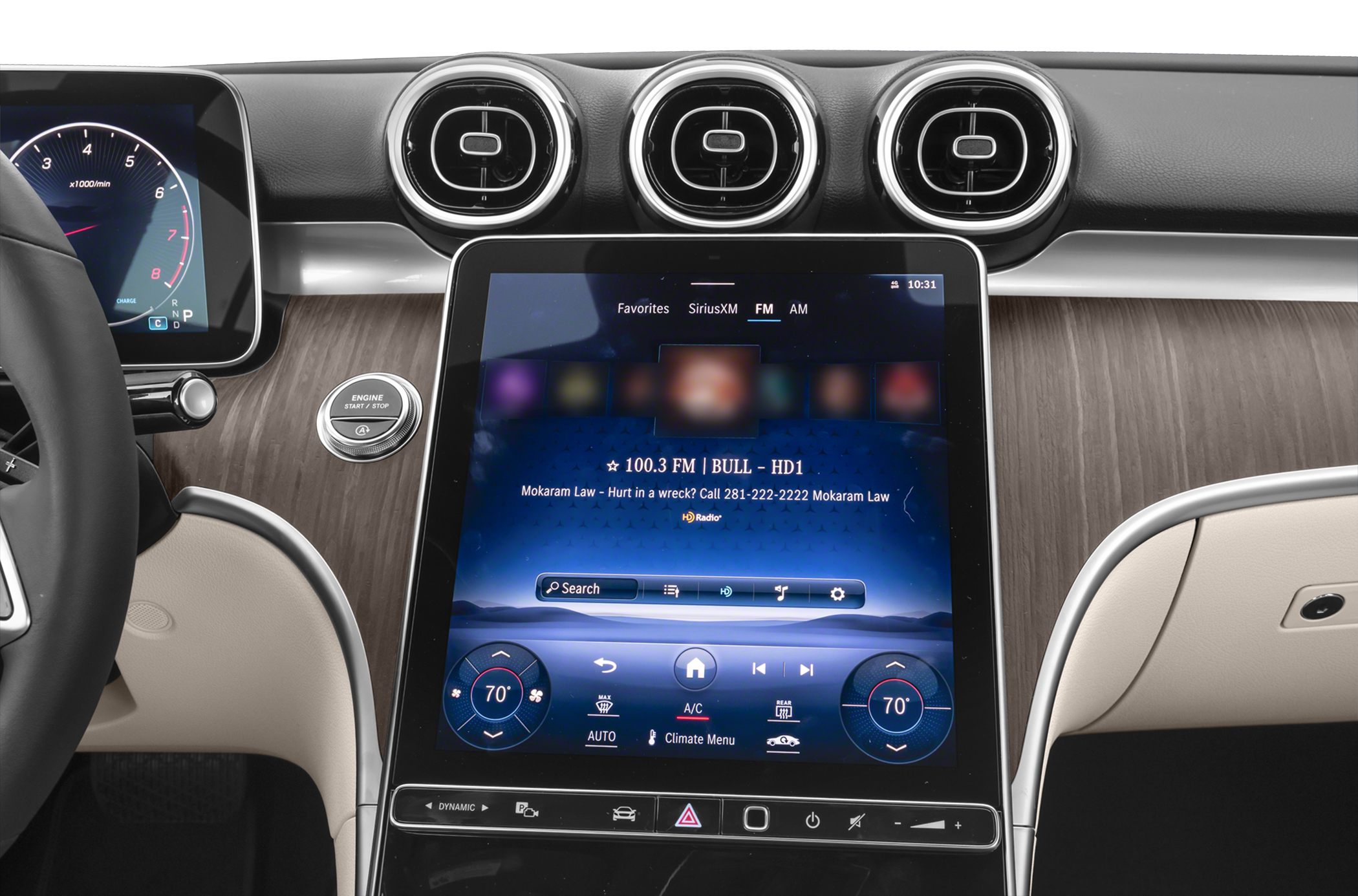 Large color touchscreen and three round air vents on wood trim dashboard