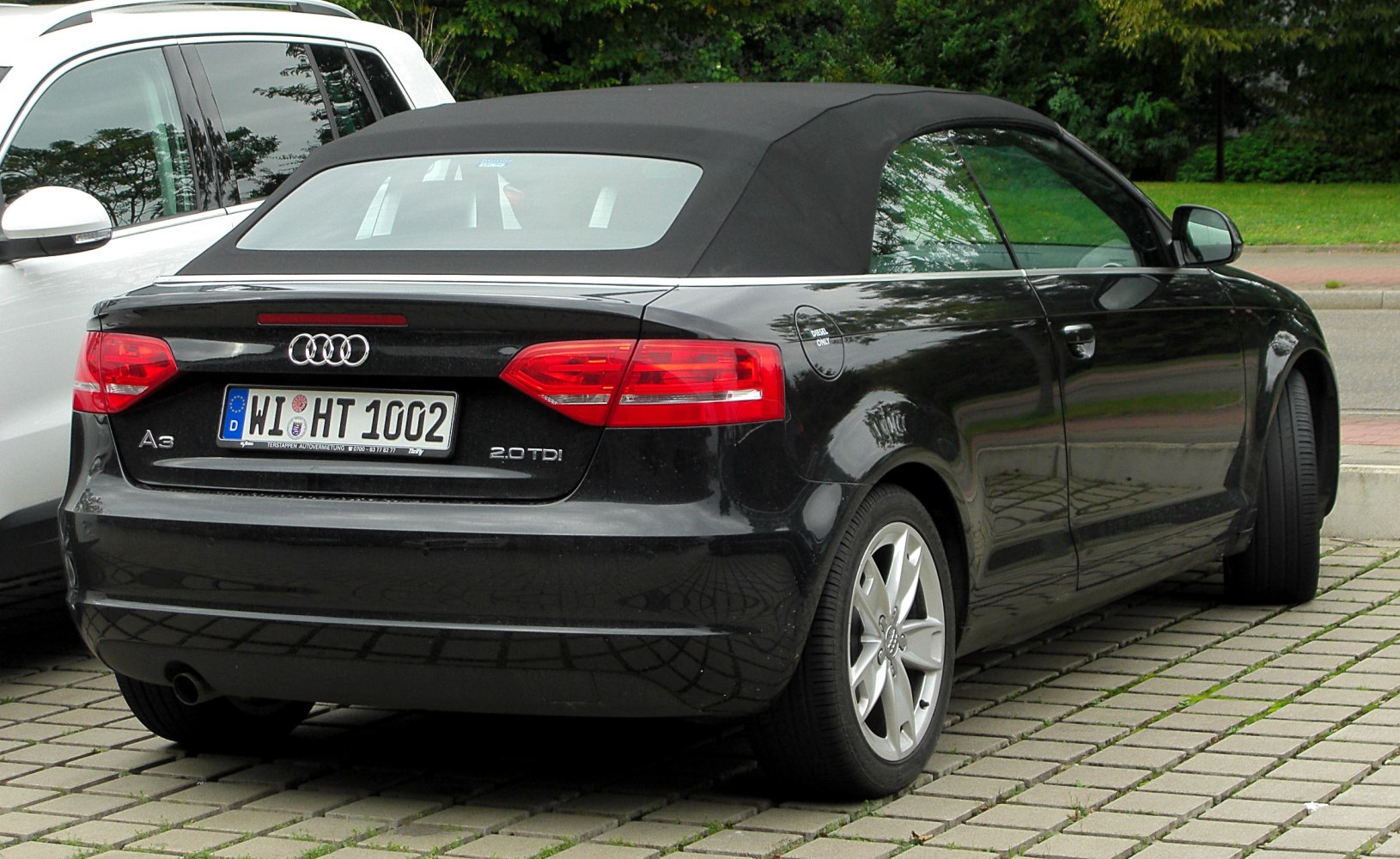 Rear view of black convertible with soft top and 2.0 TDI badge