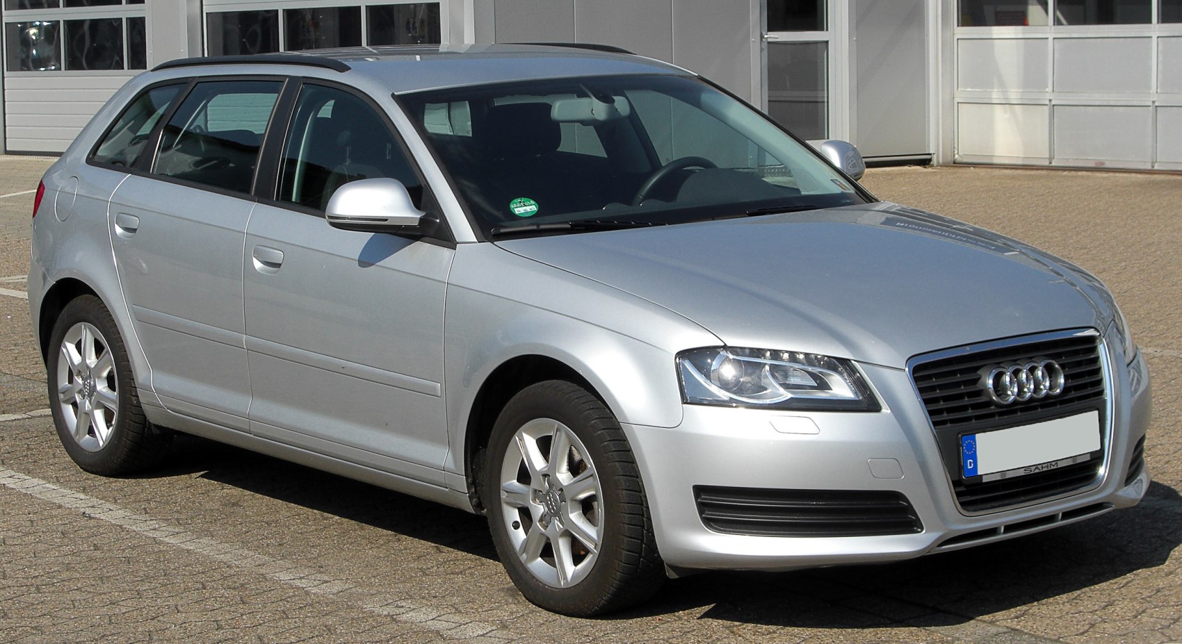 Front side view of a silver compact hatchback with LED headlights and alloy wheels