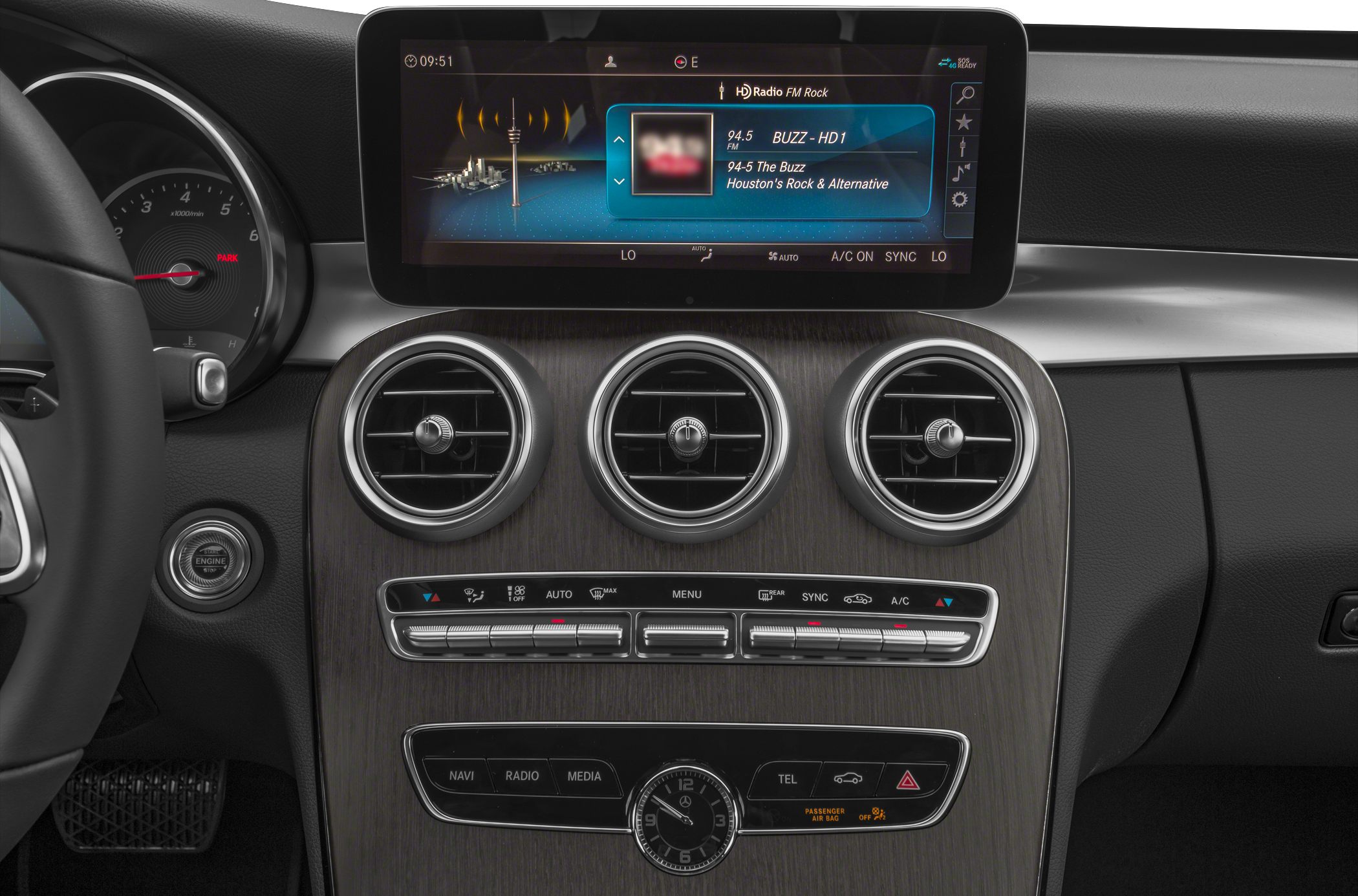 Dashboard with touchscreen infotainment, analog clock, and round air vents