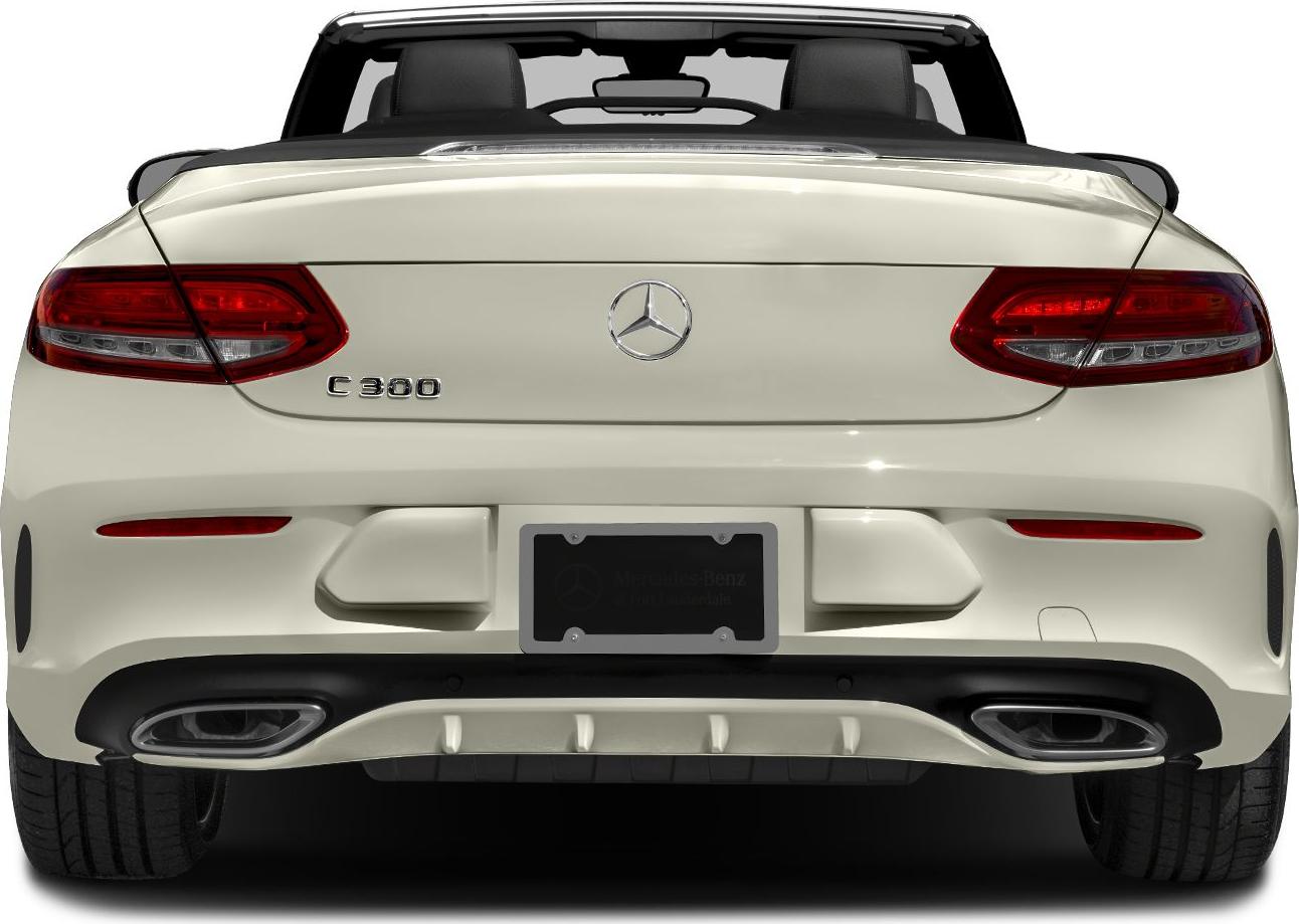 Rear view of a convertible with illuminated taillights and dual exhaust outlets