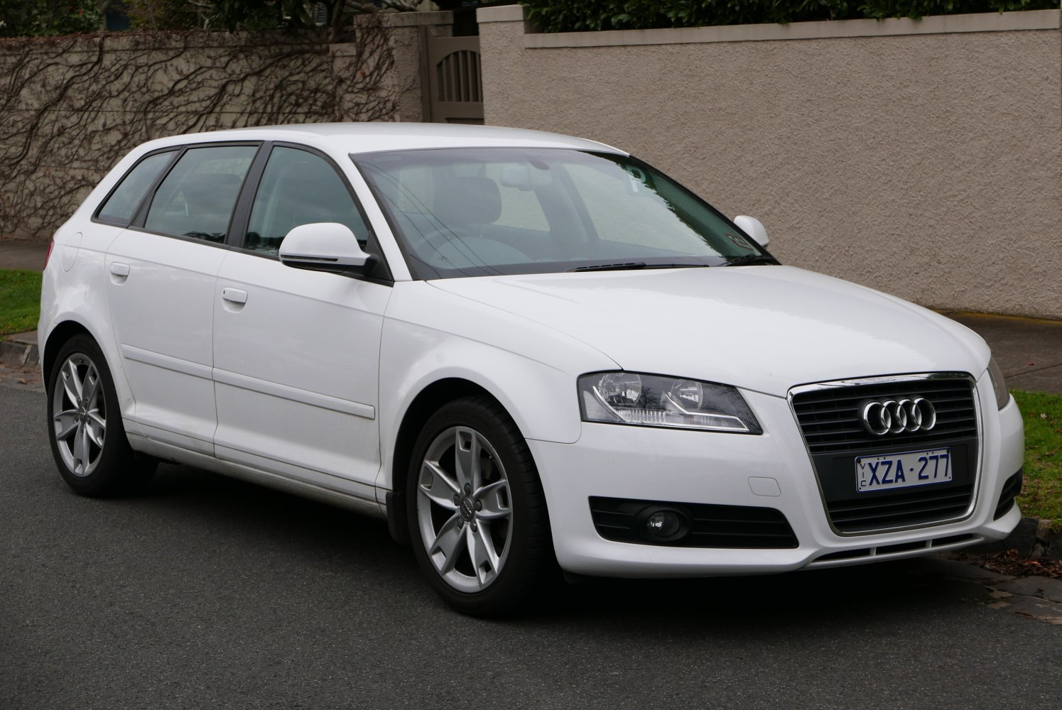 White 5-door hatchback with facelift front grille and alloy wheels